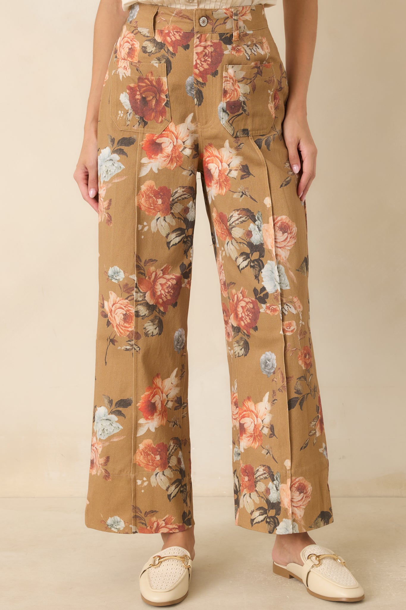 Close view of the high-rise waistband and pressed front seams highlighting the tailored construction.