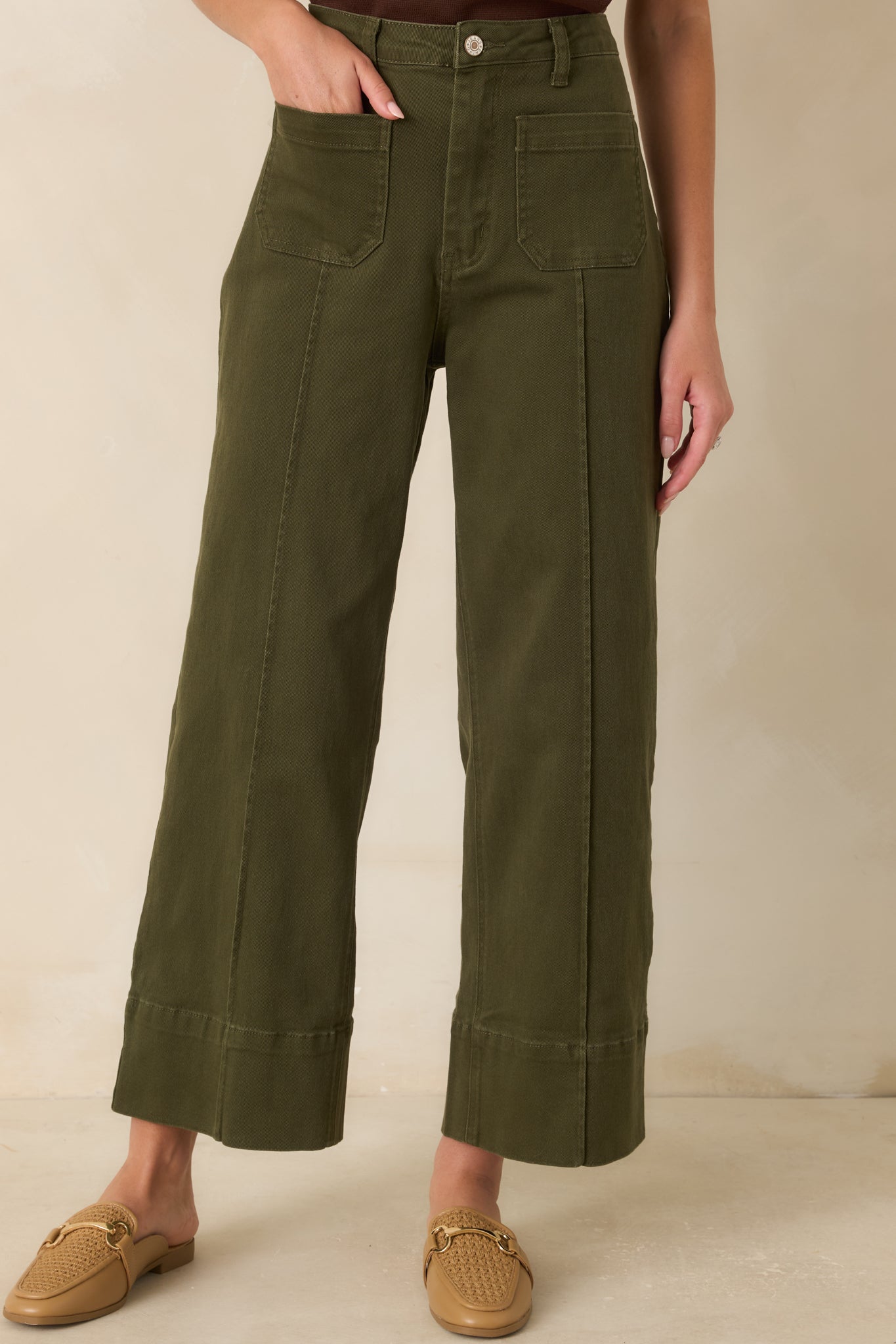 Close view of the high-rise waistband featuring belt loops, clean tailoring, and utility-inspired pocket detailing.