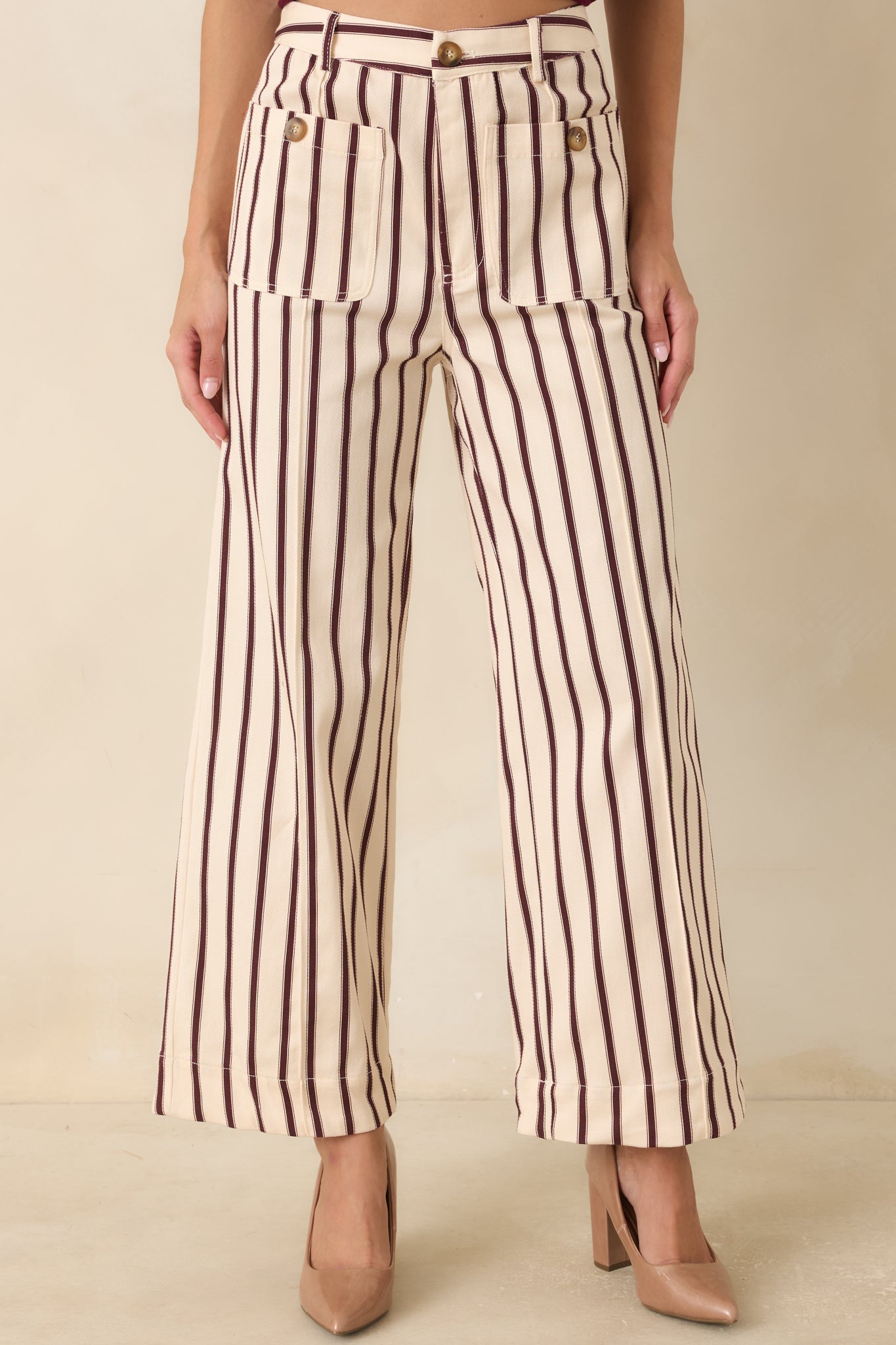 Close view of the high-rise waistband and burgundy ivory vertical stripe pattern on the cotton blend pants.