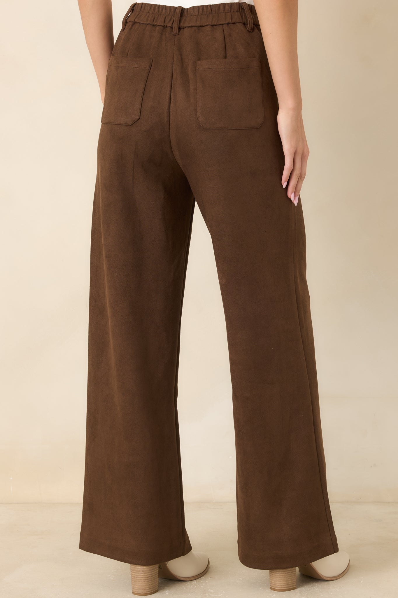 Rear view of the full-length wide-leg pants showing the elasticized back waistband and functional back patch pockets.