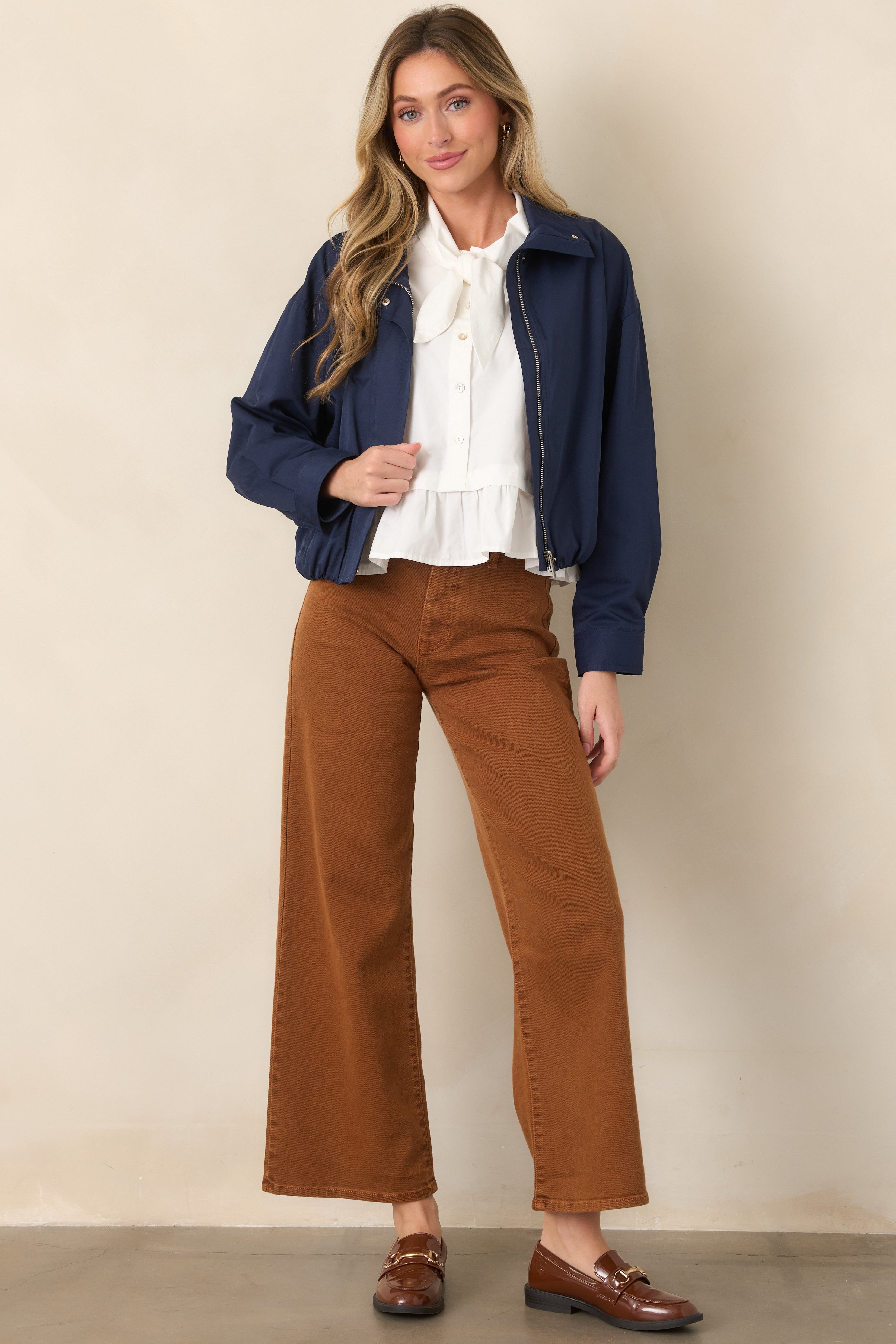 Relaxed wide-leg pants featuring a high-rise waist, classic five-pocket styling, belt loops, and an ankle-grazing hem in cotton-rich stretch denim.