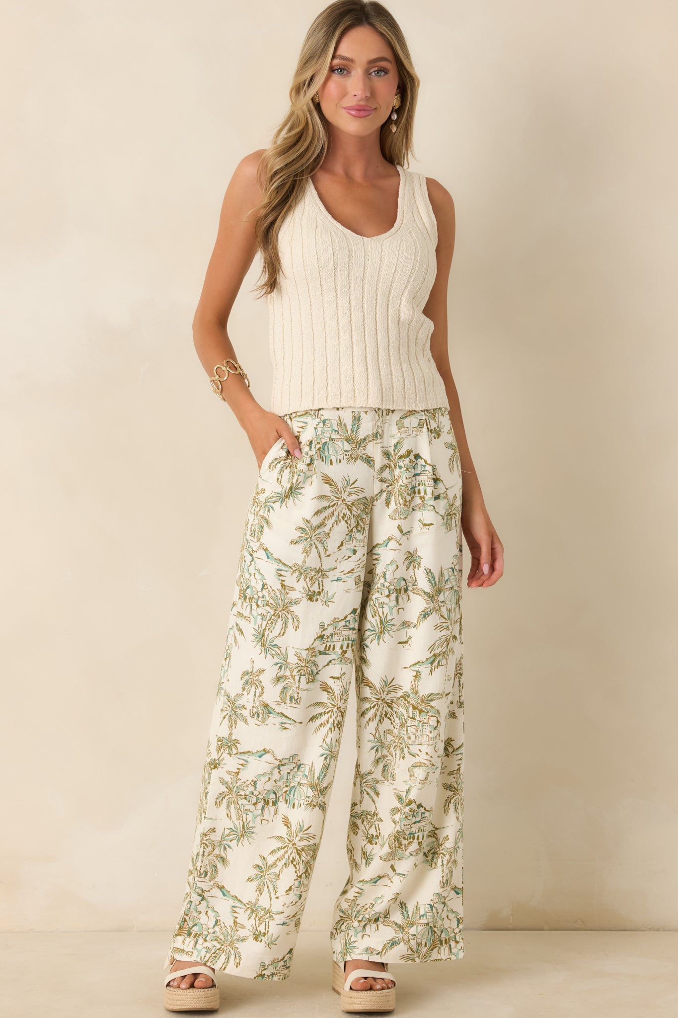 High-rise wide-leg pants showcasing a flowing full-length design with an allover tropical landscape-inspired pattern.