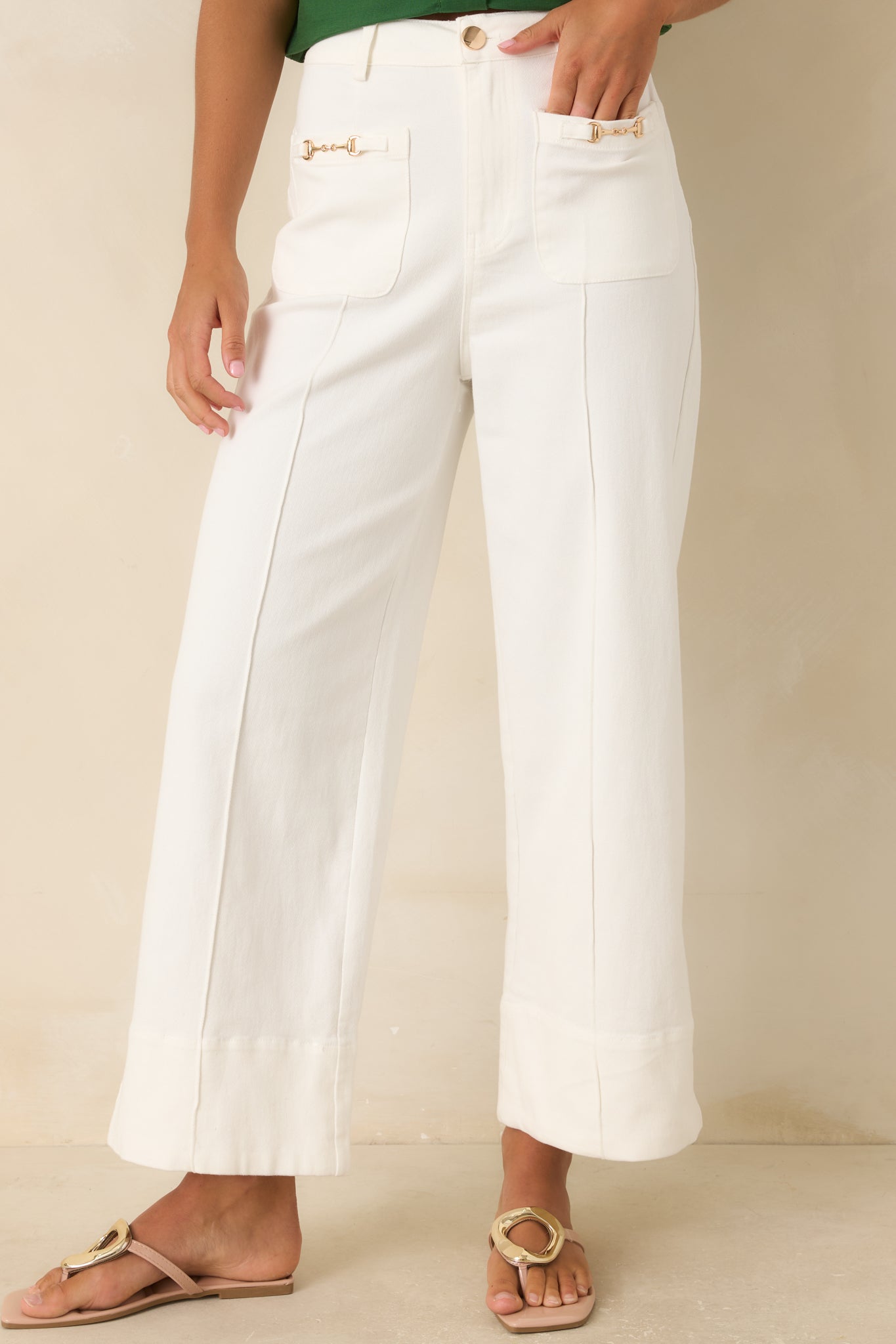 High-rise wide leg pants showcasing the tailored waistband, front pleats, and smooth structured fabric.