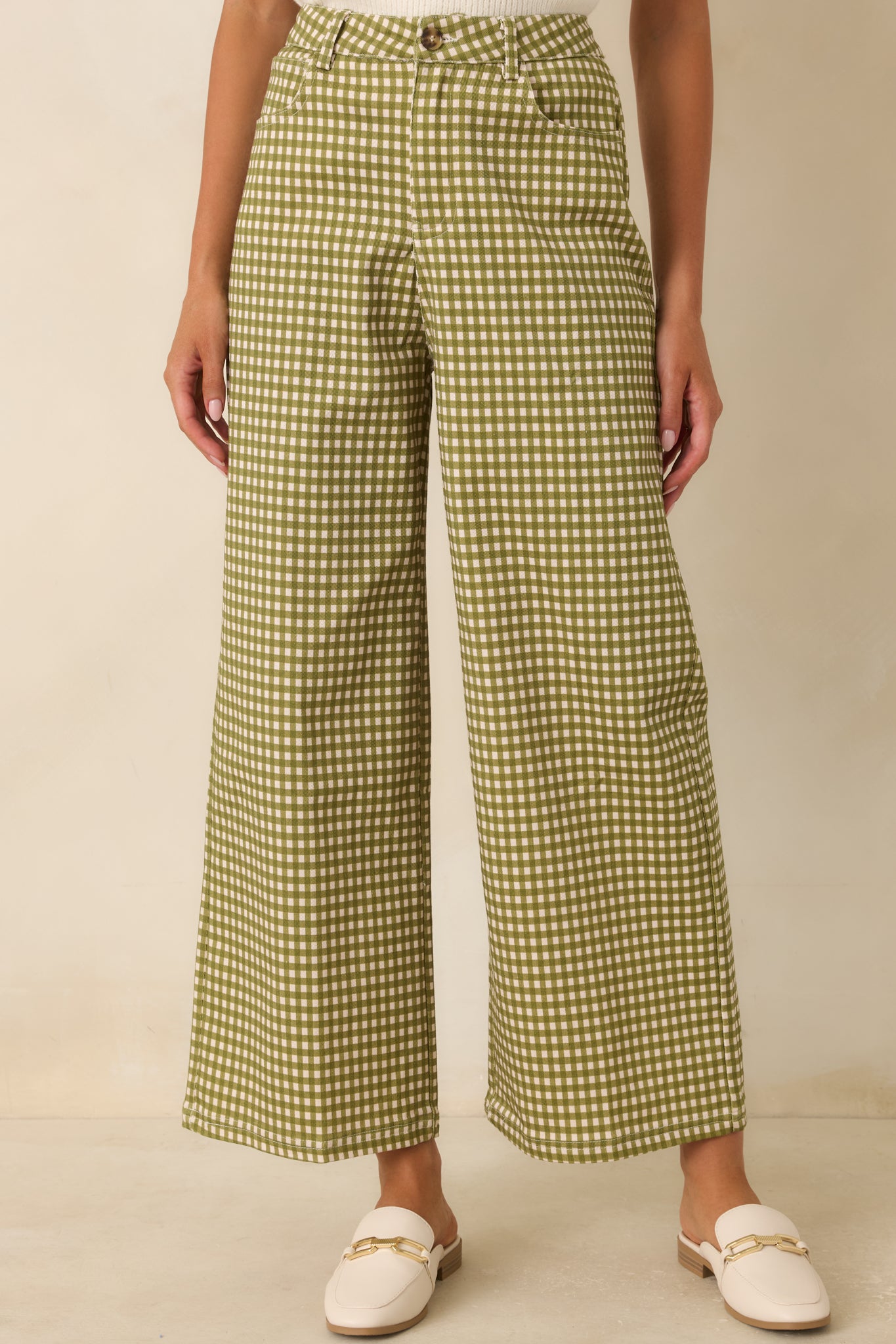 High-rise waistband features belt loops and a classic zip-and-button closure for a refined fit.