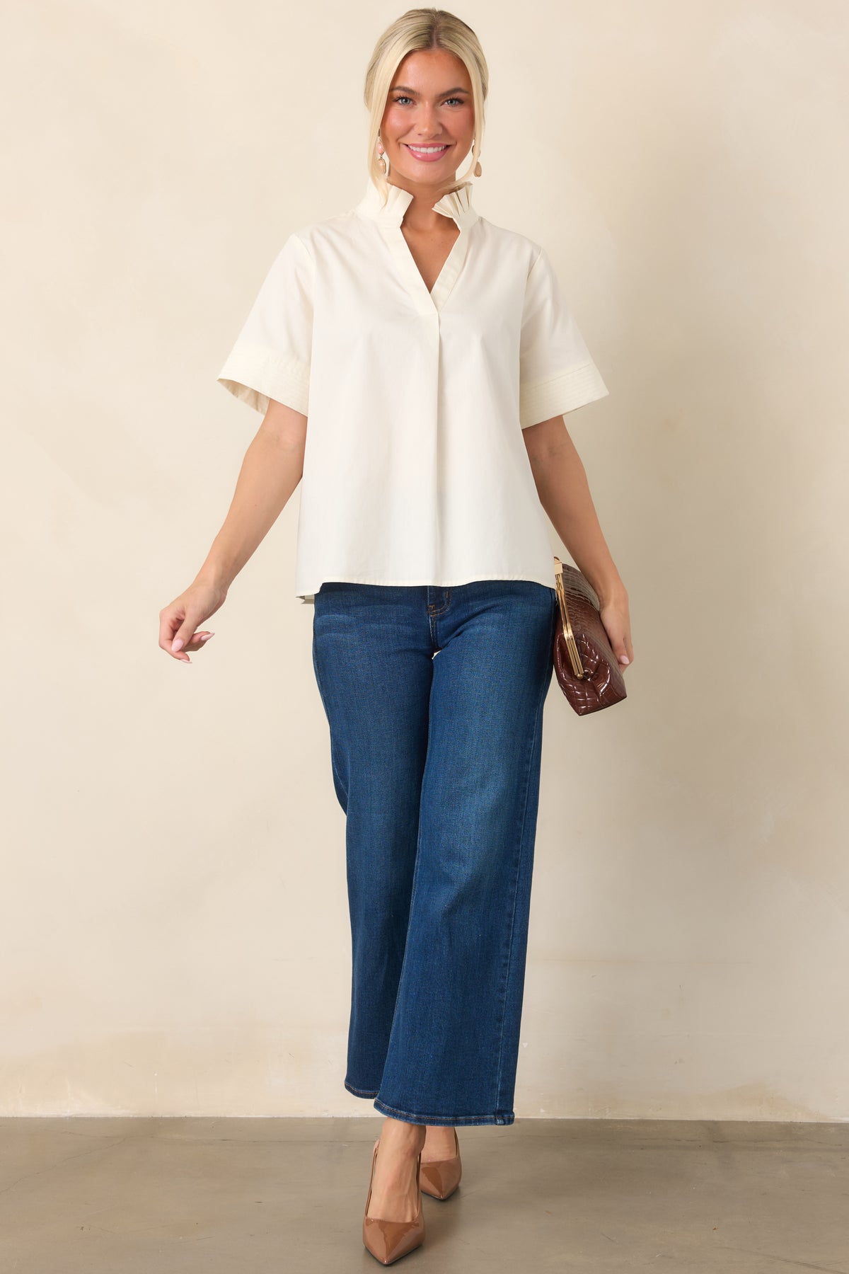 High-waisted dark denim jeans with a relaxed wide leg shape, cropped hem, belt loops, and classic five-pocket styling.