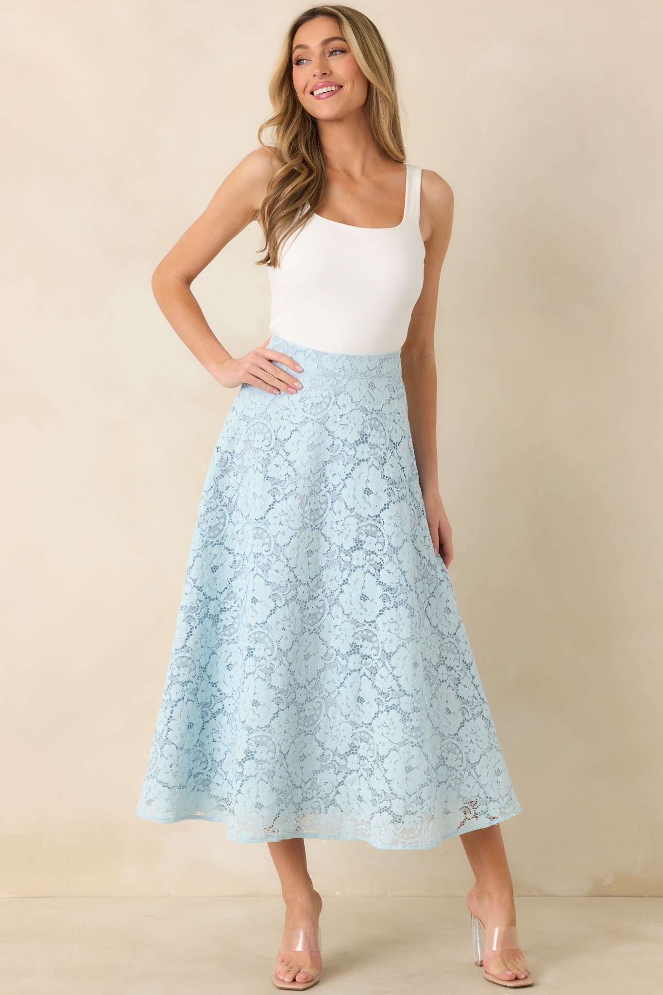 High-waisted light blue skirt with delicate cutout pattern and smooth inner lining.