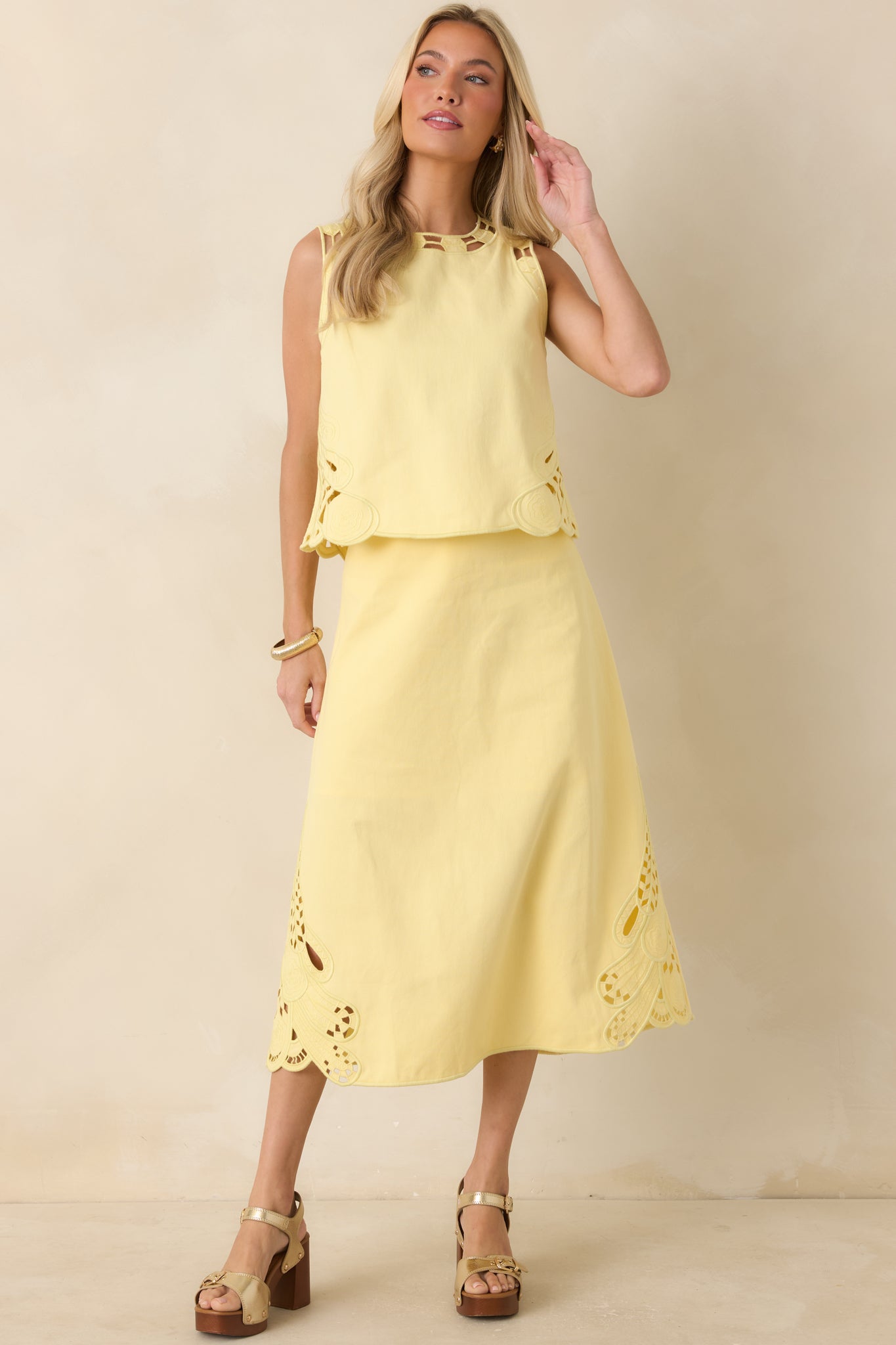 High-waisted yellow skirt showcasing a clean, structured fit and a softly flared A-line midi length.