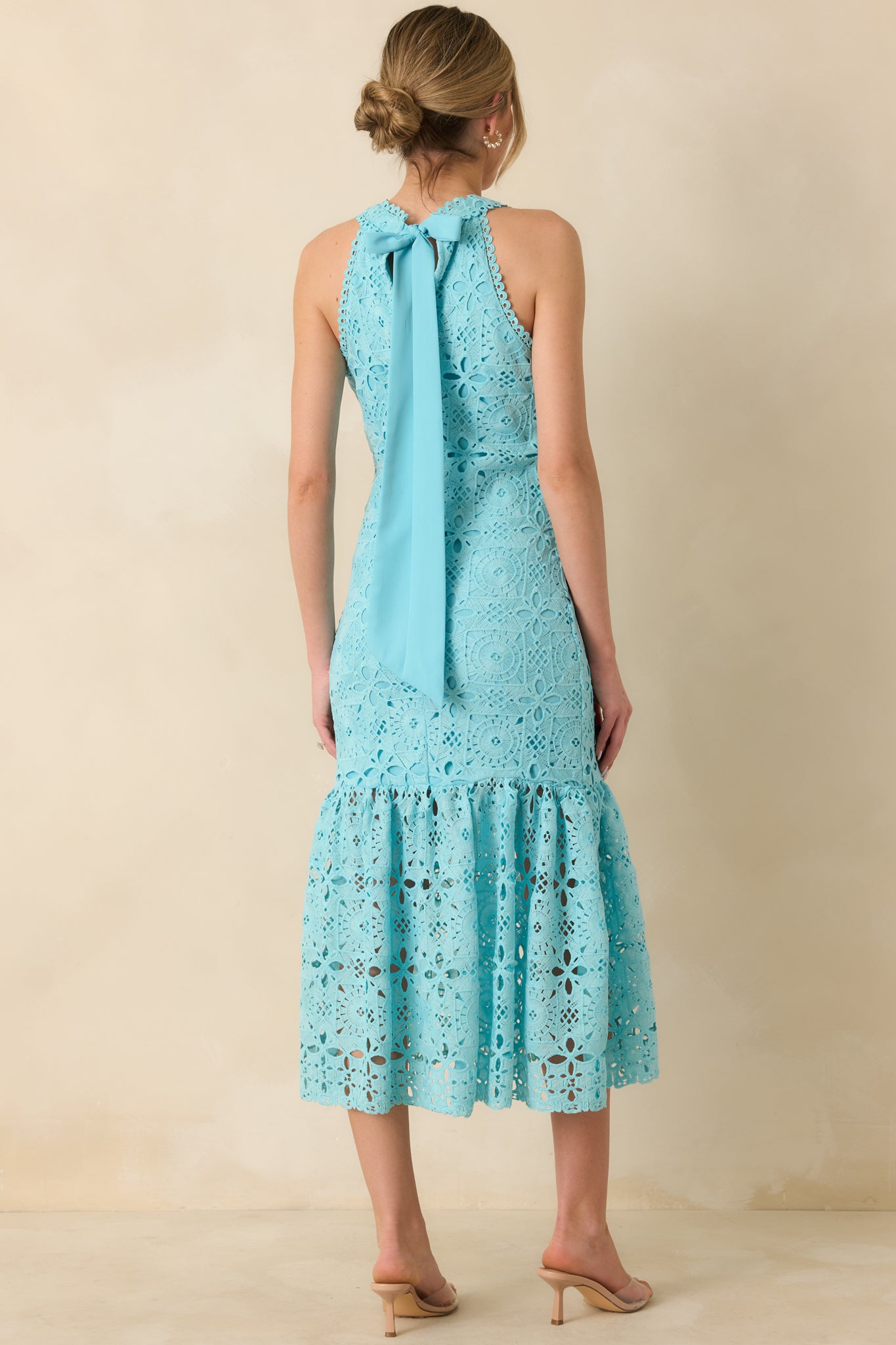 Back view showing adjustable self-tie bow closure, hidden zipper, and flowing tiered skirt of horizon blue maxi dress.
