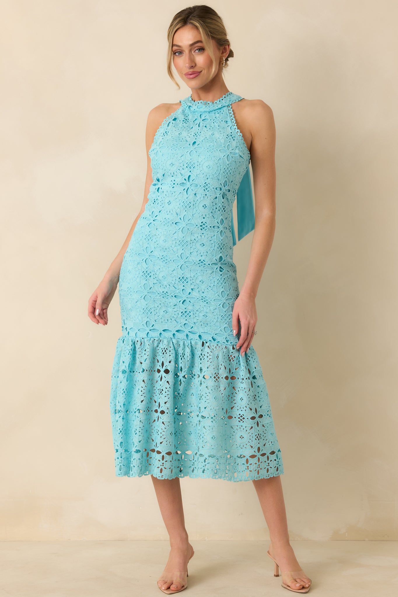 Front perspective showing embroidered geometric floral details and flowing bottom tiers of horizon blue maxi dress.