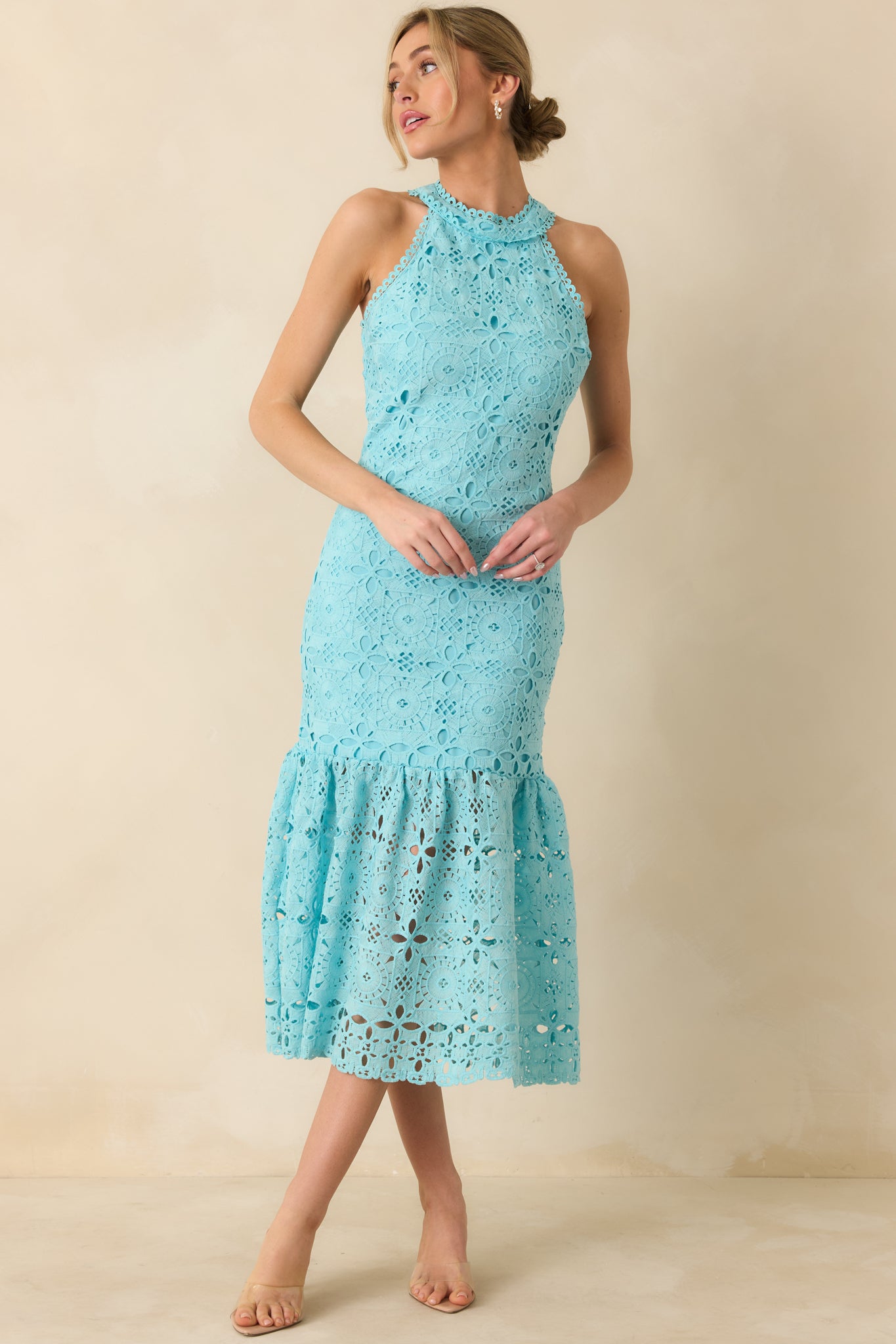 Full-length shot emphasizing the halter neckline, embroidered floral design, and open eyelet accents.