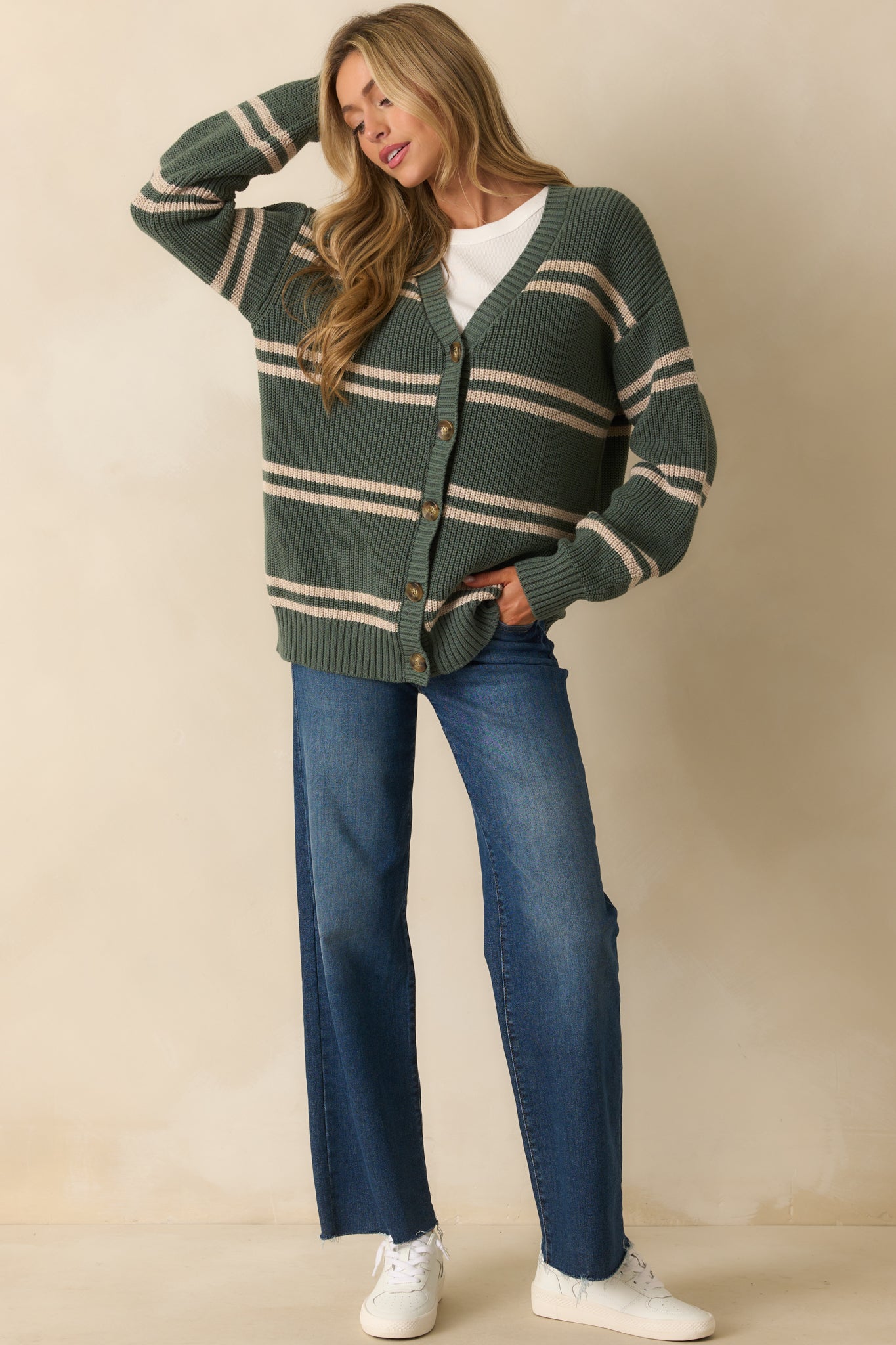 Horizontal striped green cardigan with ribbed hems, long sleeves, and a comfortable relaxed silhouette.