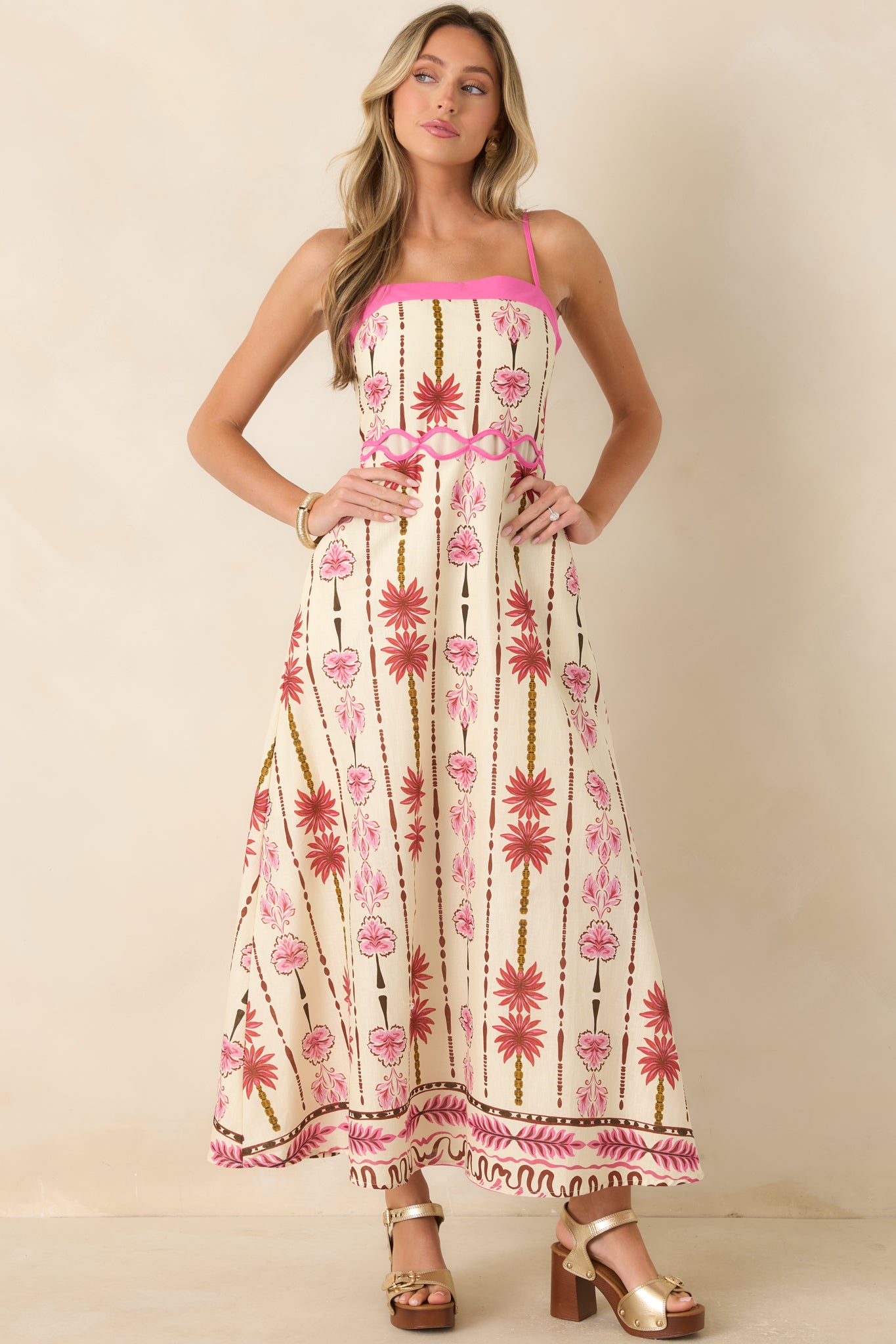 Romantic floral maxi dress featuring vibrant hot pink accents, smocked bodice, waist cutout trim, and lightweight fabric.