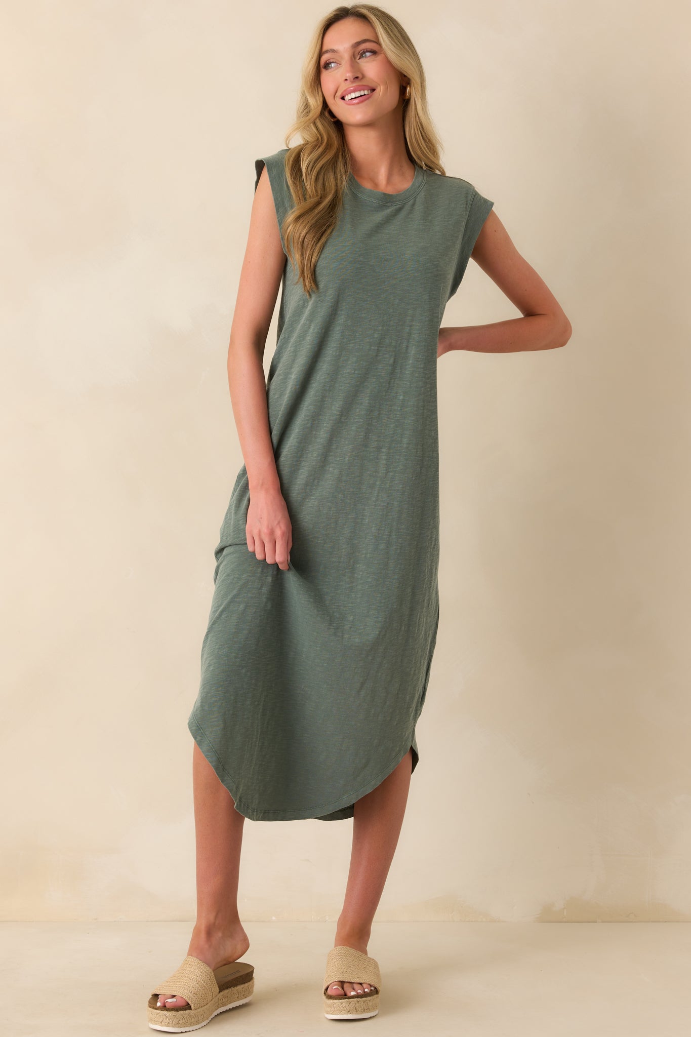 Full body image of the hunter green midi dress displaying its loose fit and mid-calf length from the front angle.