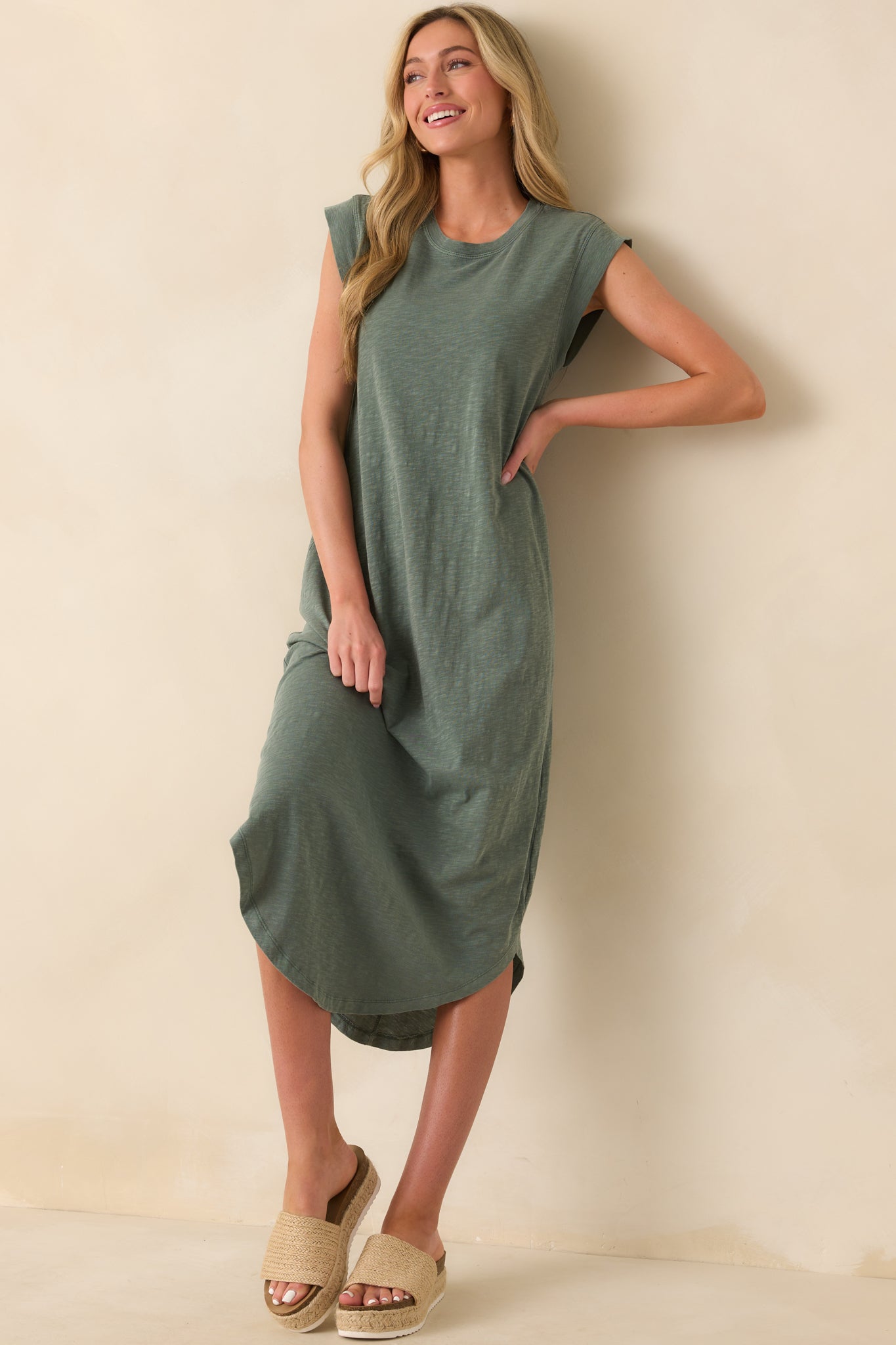 Front full-length shot showing the simple, elegant shape and smooth finish of the hunter green midi dress.