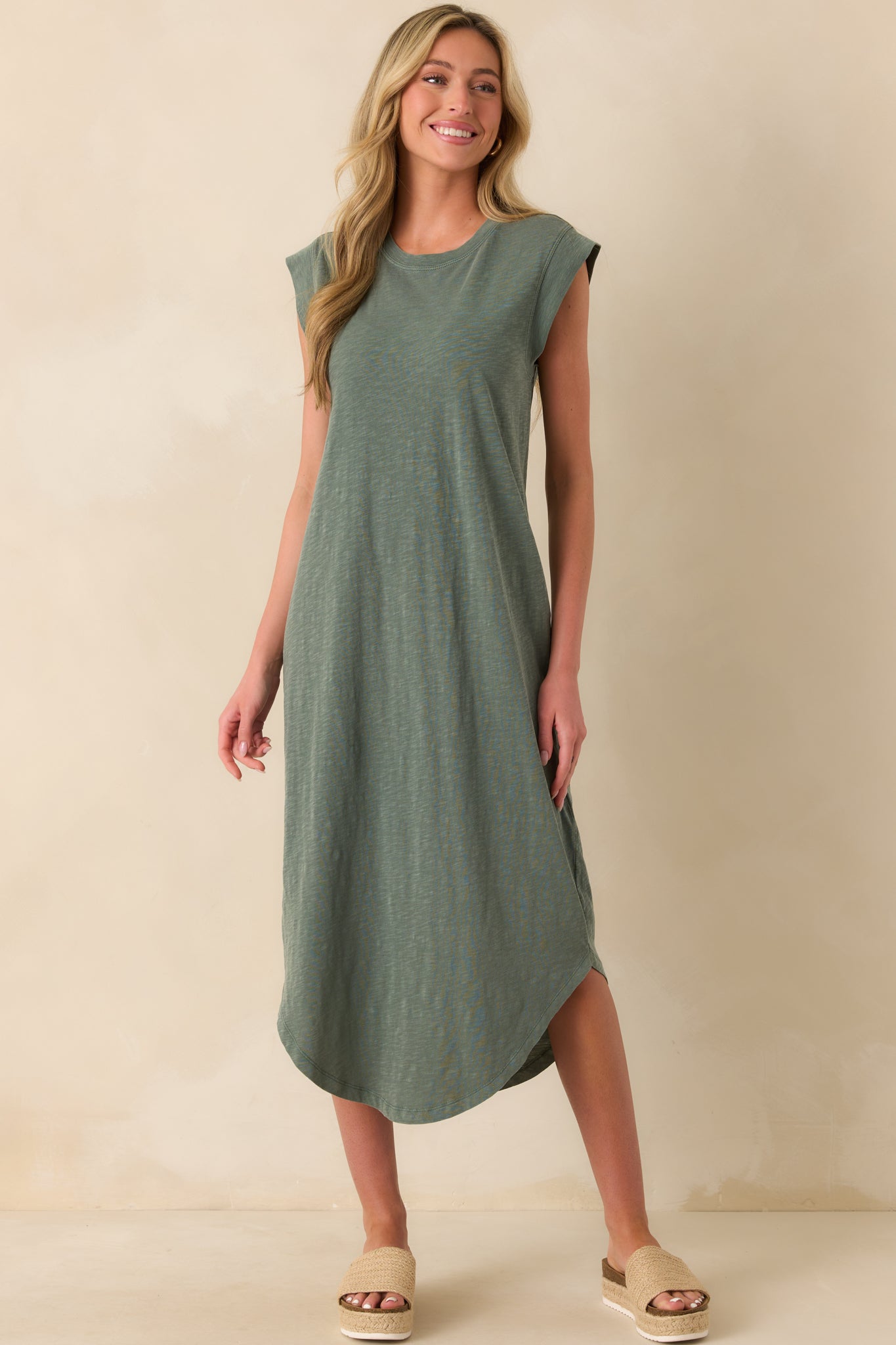 Full body view of the hunter green midi dress showing the crew neckline, short cap sleeves, and relaxed silhouette from head to toe.