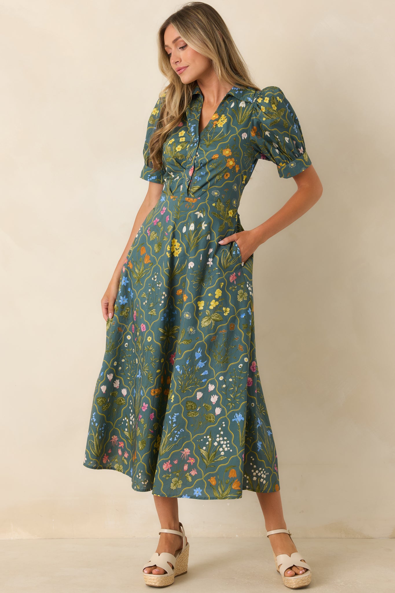 Hunter green cotton dress featuring a defined waist, cuffed puff sleeves, and an elegant midi-length silhouette.