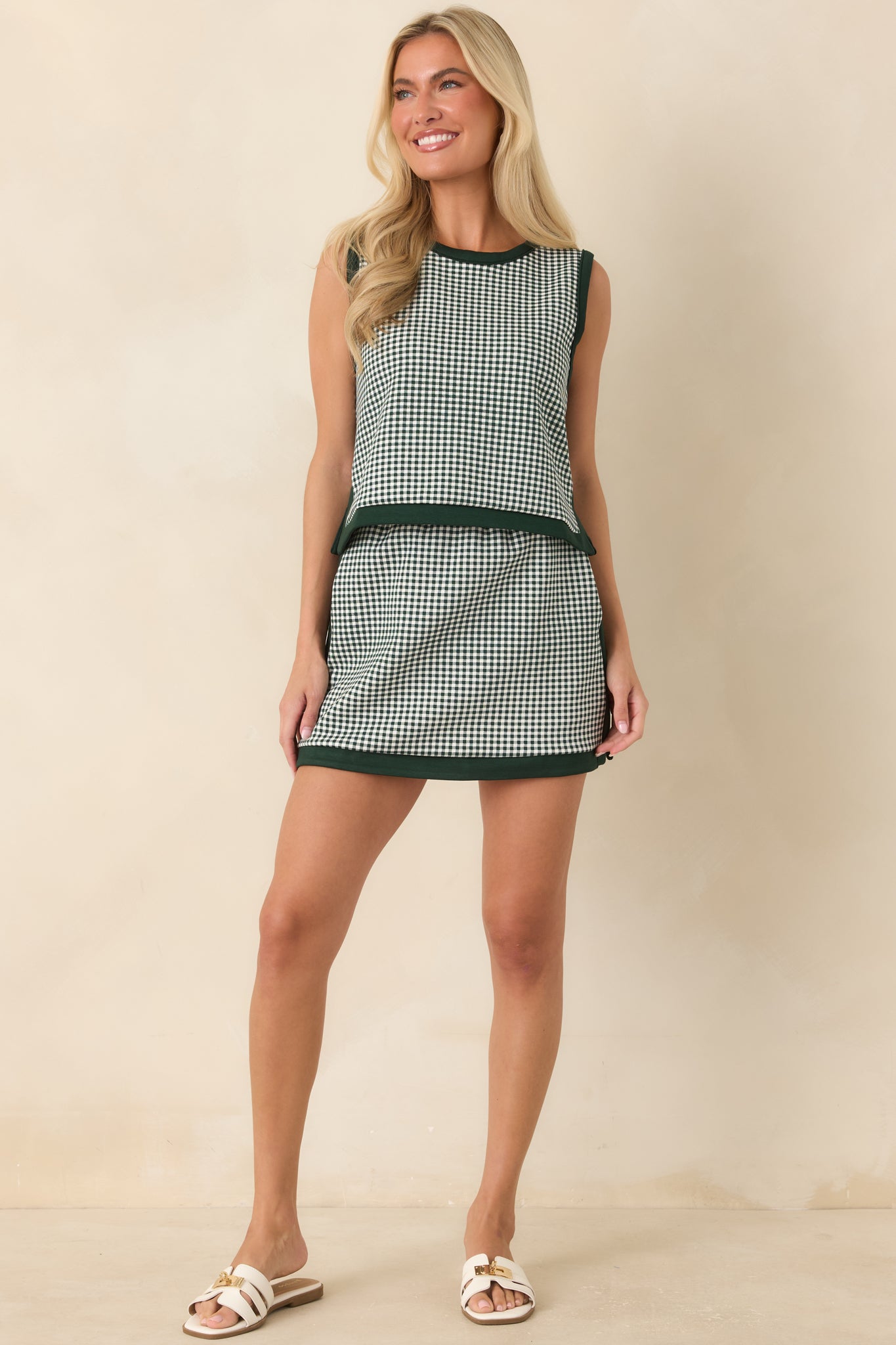 Hunter green gingham blouse featuring a relaxed cropped silhouette and polished fabric-covered buttons.