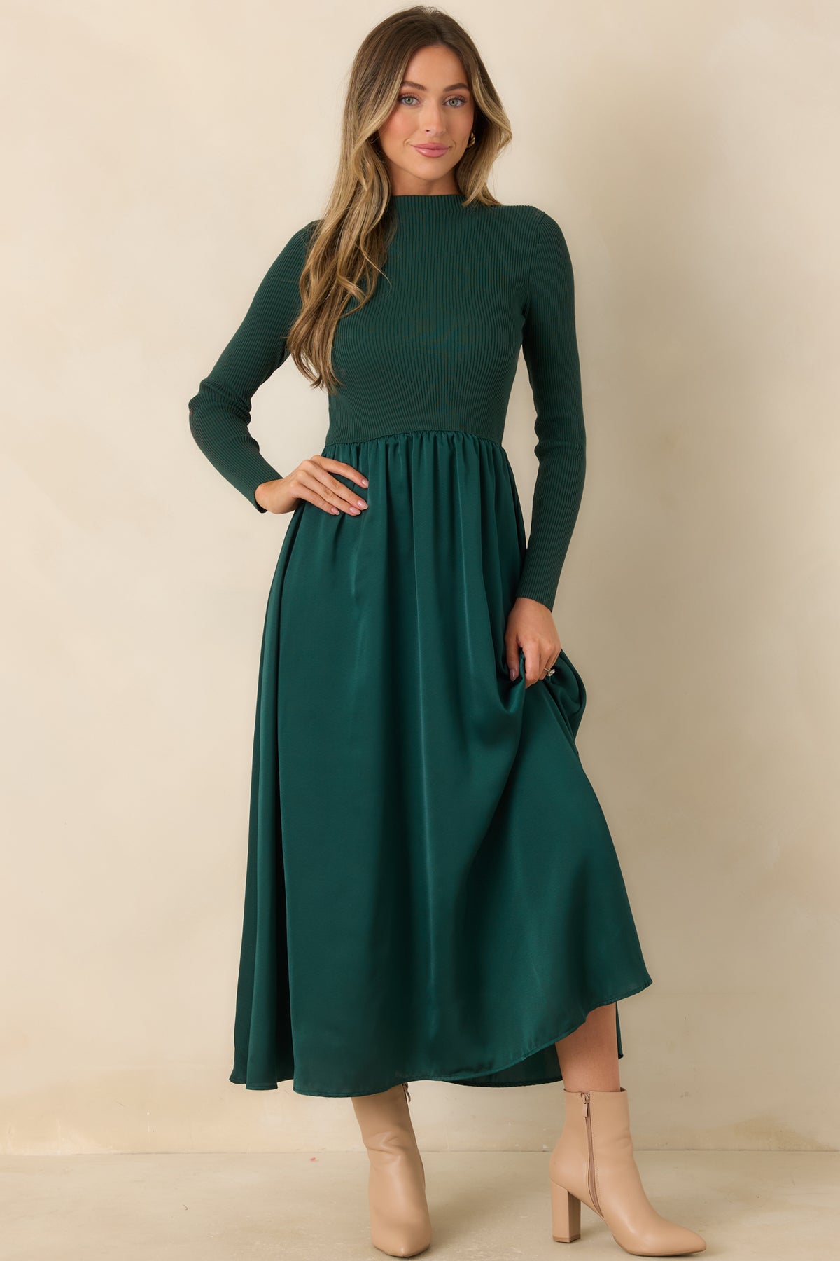 Long-sleeve hunter green dress with a fitted textured bodice and a softly gathered satin skirt.