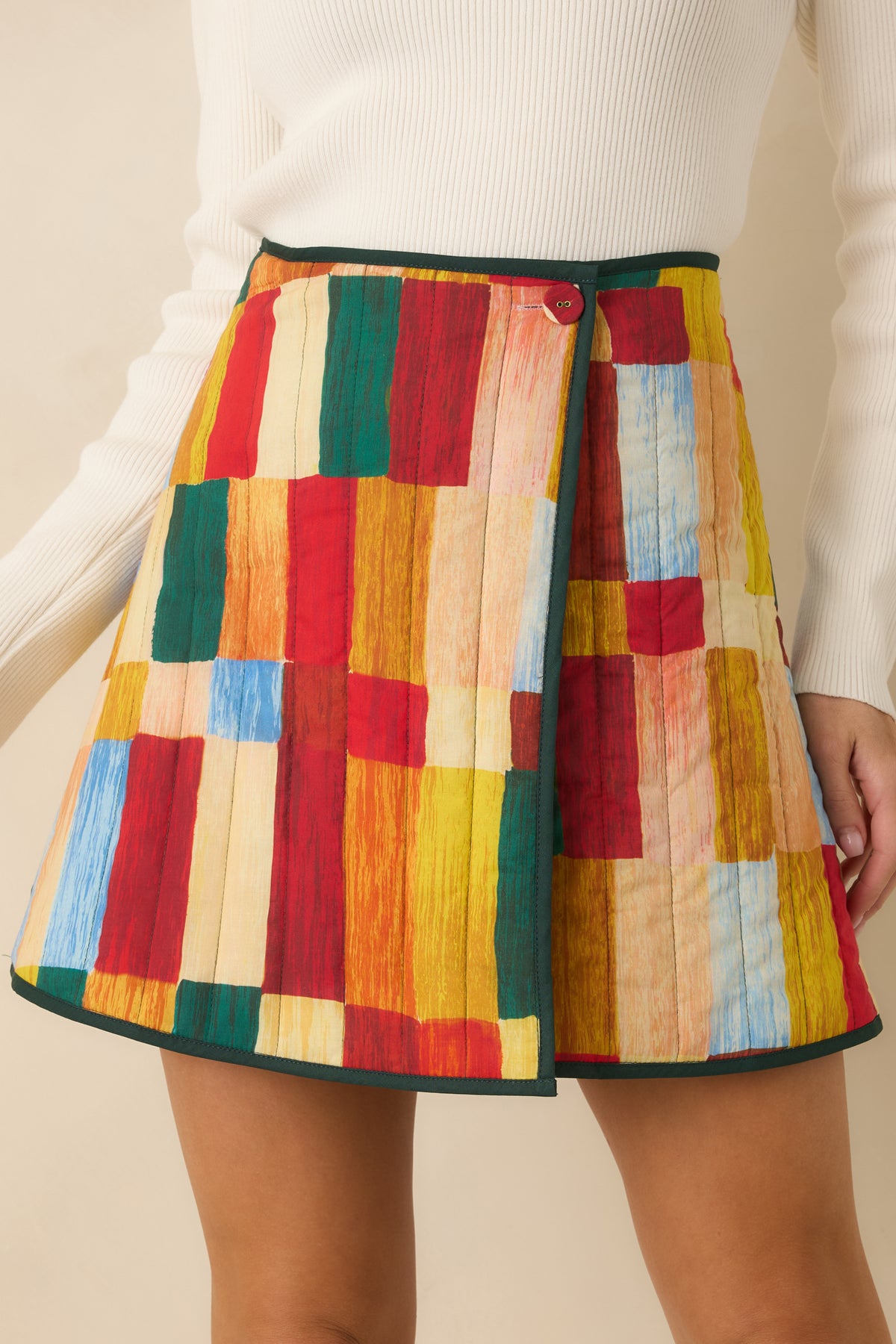 Reversible quilted skirt showcasing the solid hunter green reverse and contrasting green edge binding.