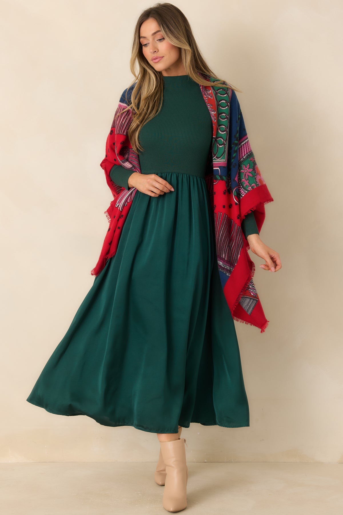 Hunter green dress with a fitted ribbed knit bodice, mock neckline, long sleeves, and flowing satin skirt.