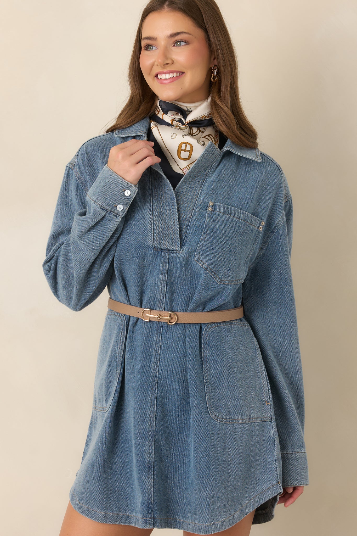Medium indigo denim dress highlighting the collared neckline, partial button placket, and structured fabric.