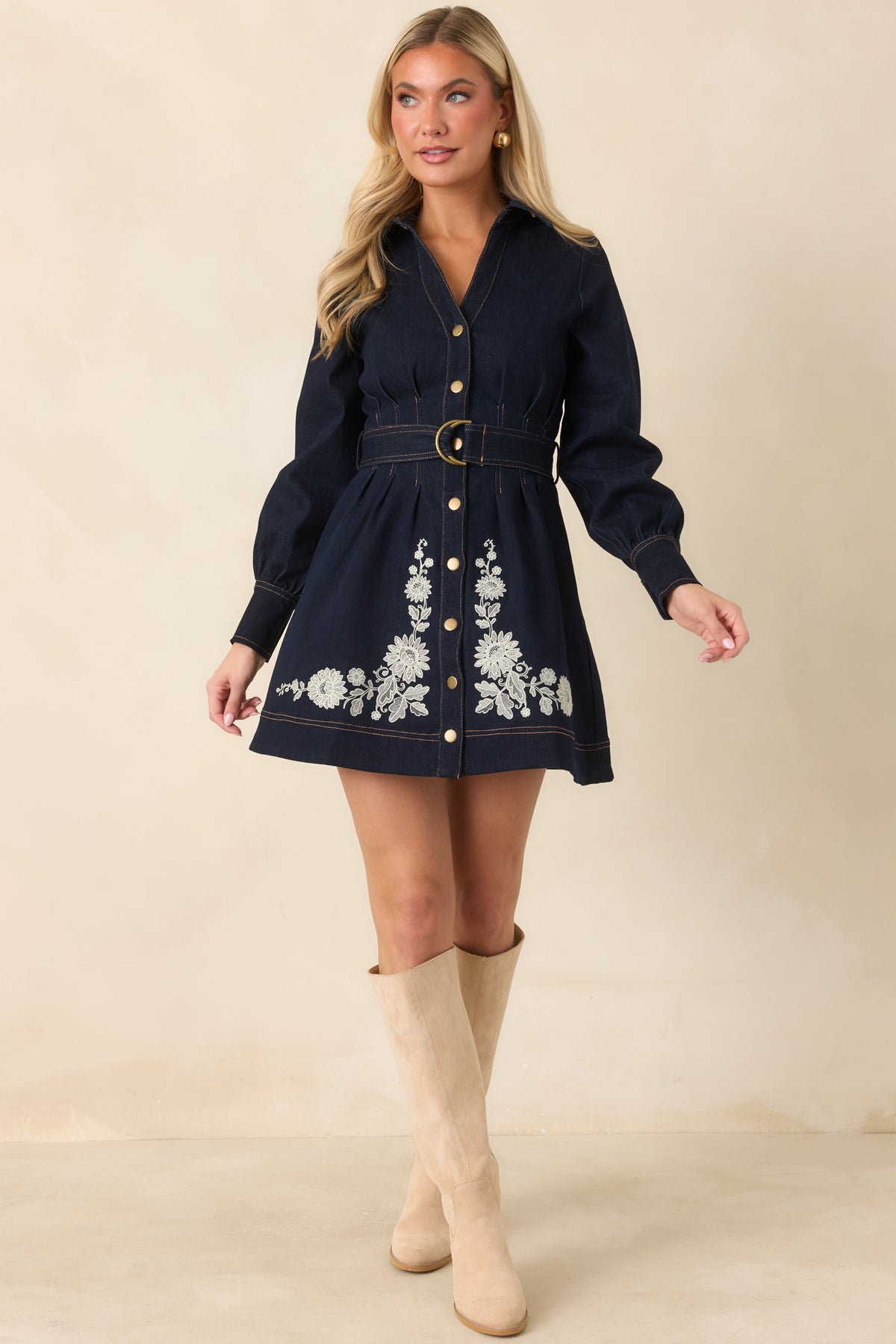 Rich indigo denim mini dress featuring a pointed collar, gold-tone button front, and matching belt.