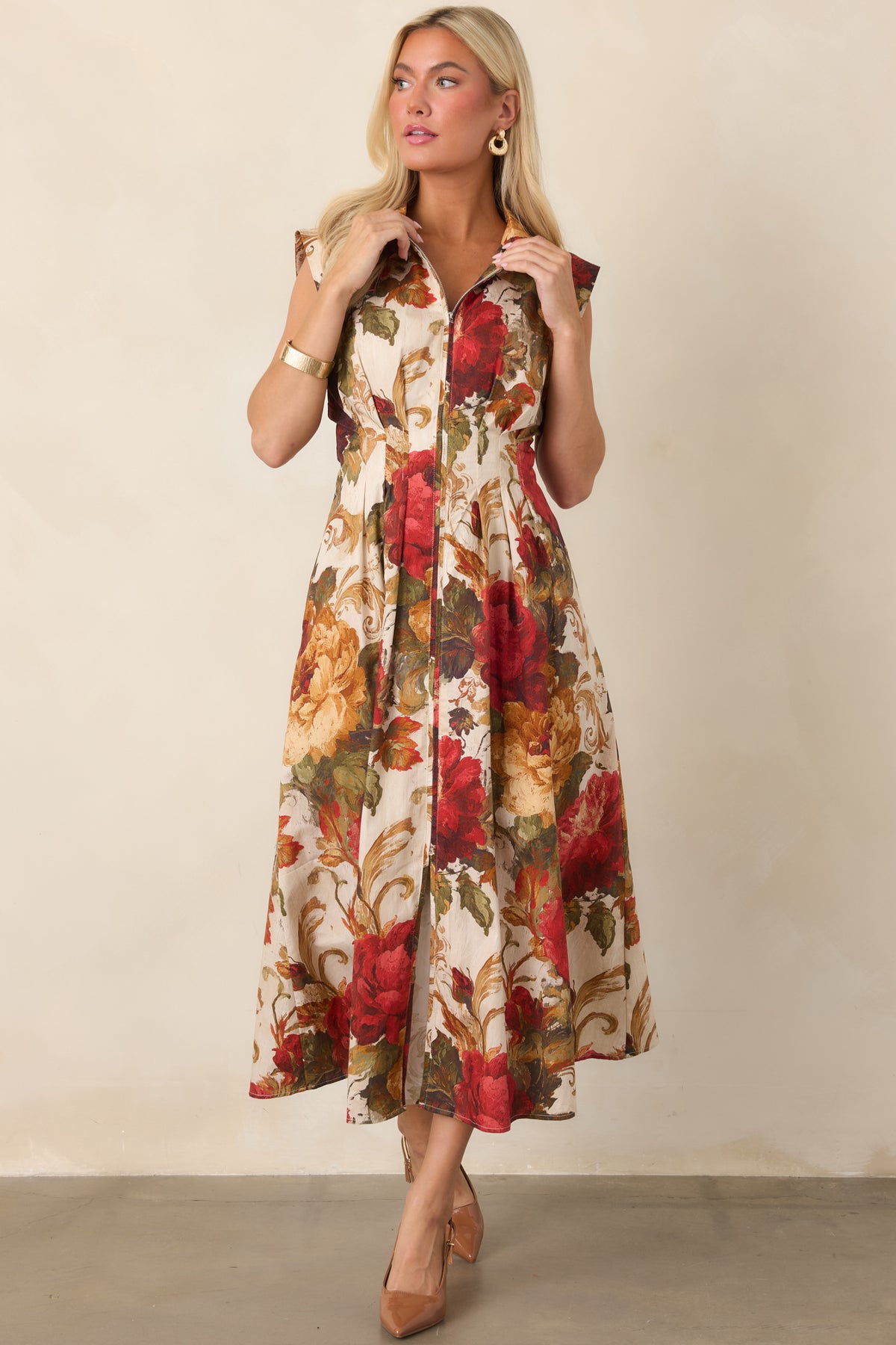Ivory A-line dress showcasing the colorful floral print and fitted waist.