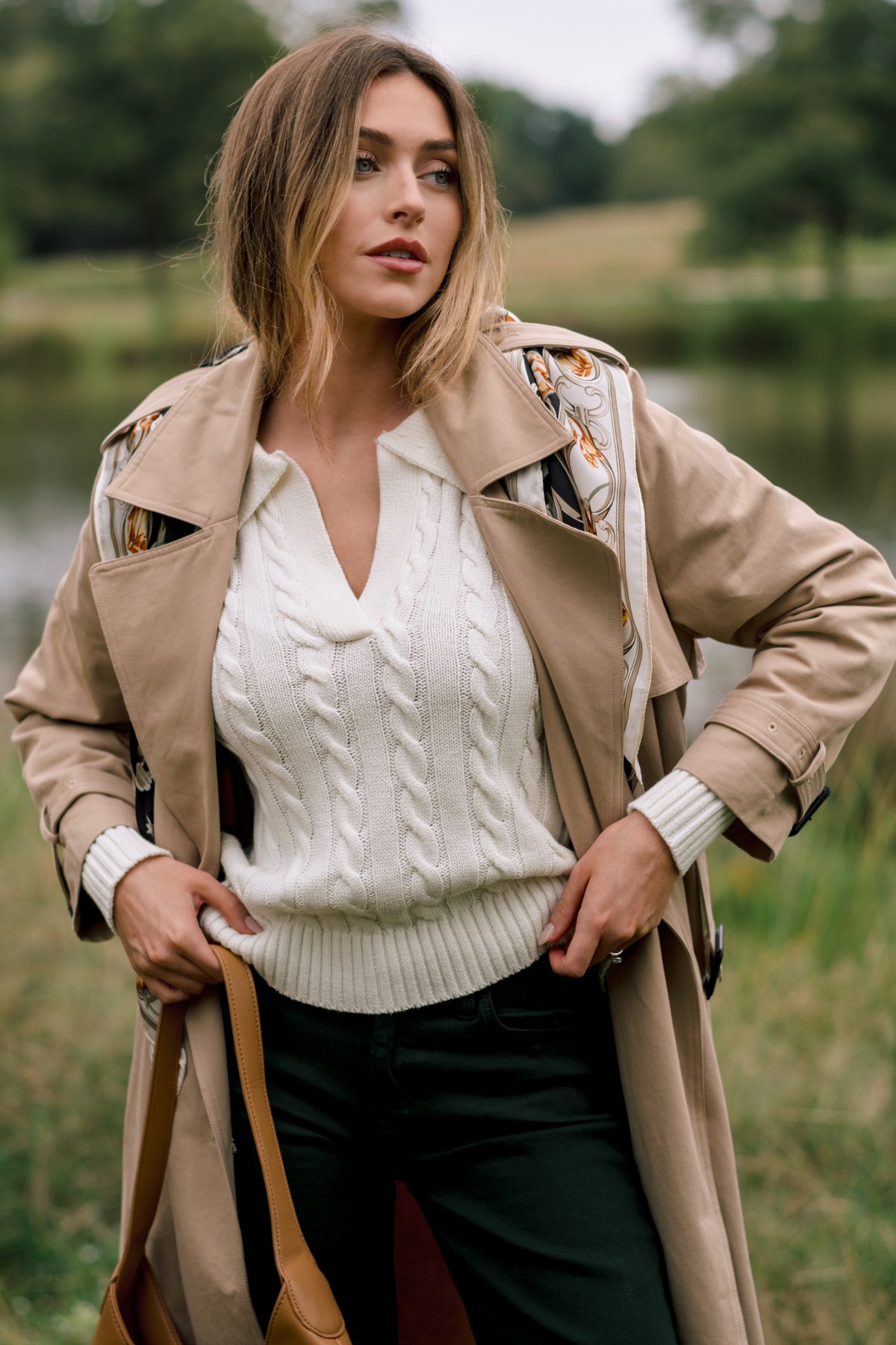 Ivory cable-knit sweater with a classic collared neckline, long sleeves, and ribbed cuffs and hem.
