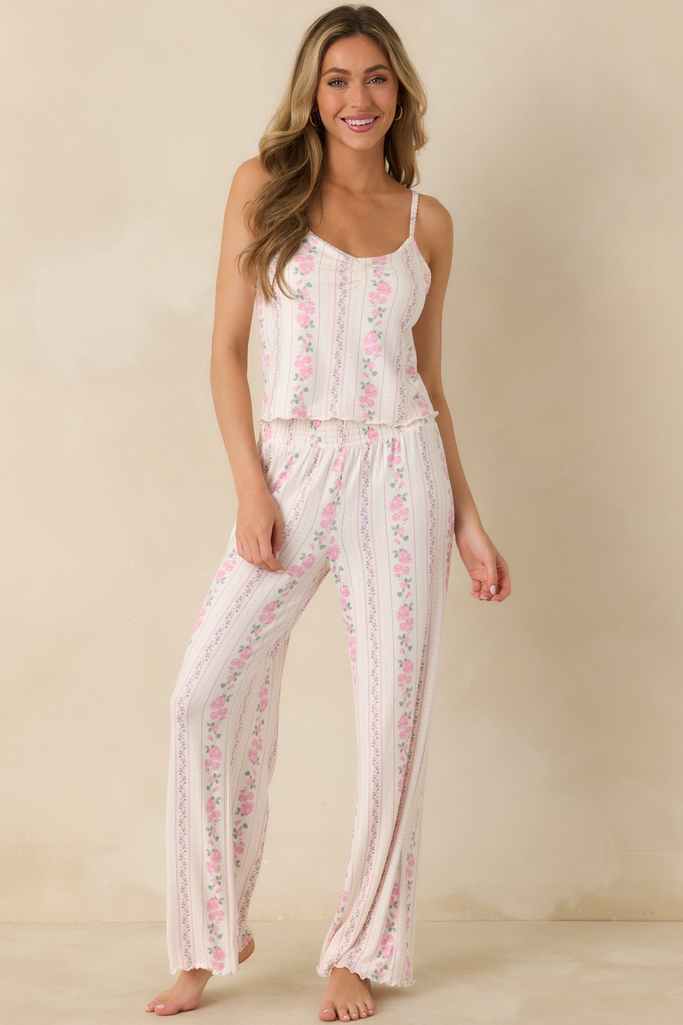 Ivory knit cami with pink floral stripe detailing, a softly gathered sweetheart neckline, and a gently ruffled hem.