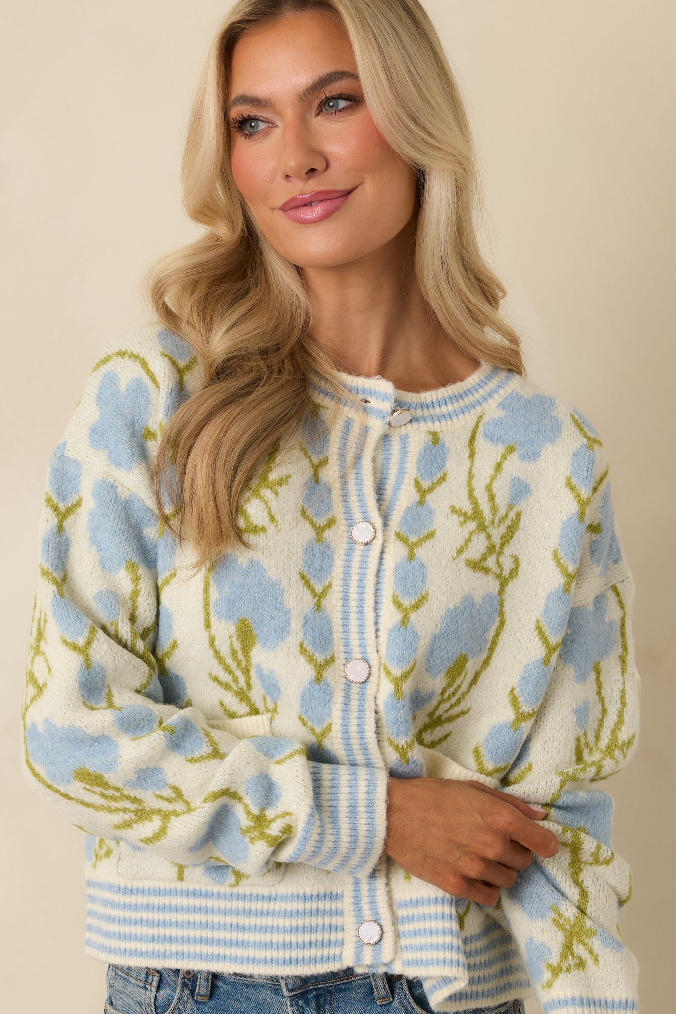 Closer view of the front patch pockets and soft knit texture with floral print.