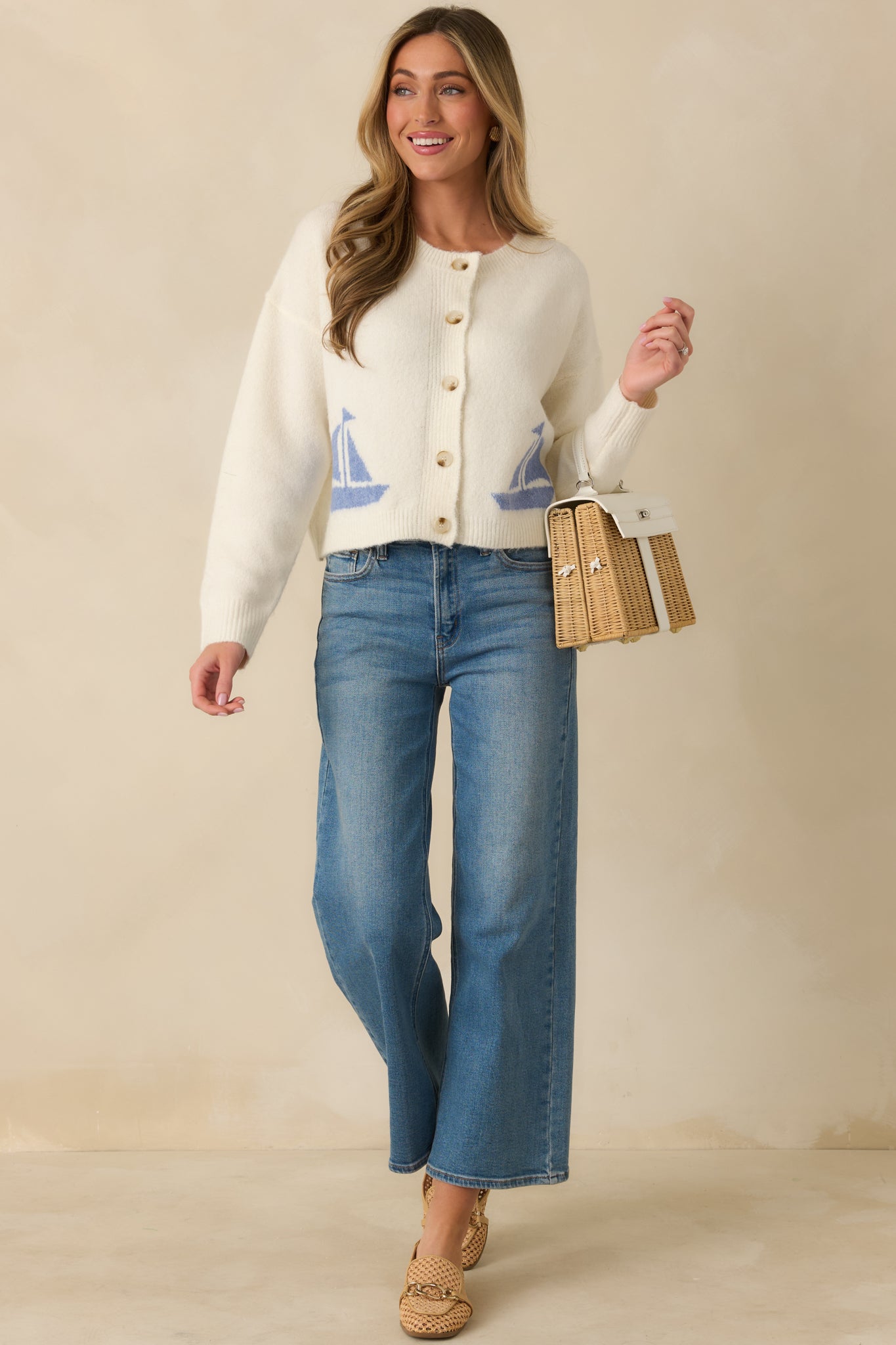 Ivory cardigan styled front-facing, featuring clean lines and soft, versatile fabric for layering.