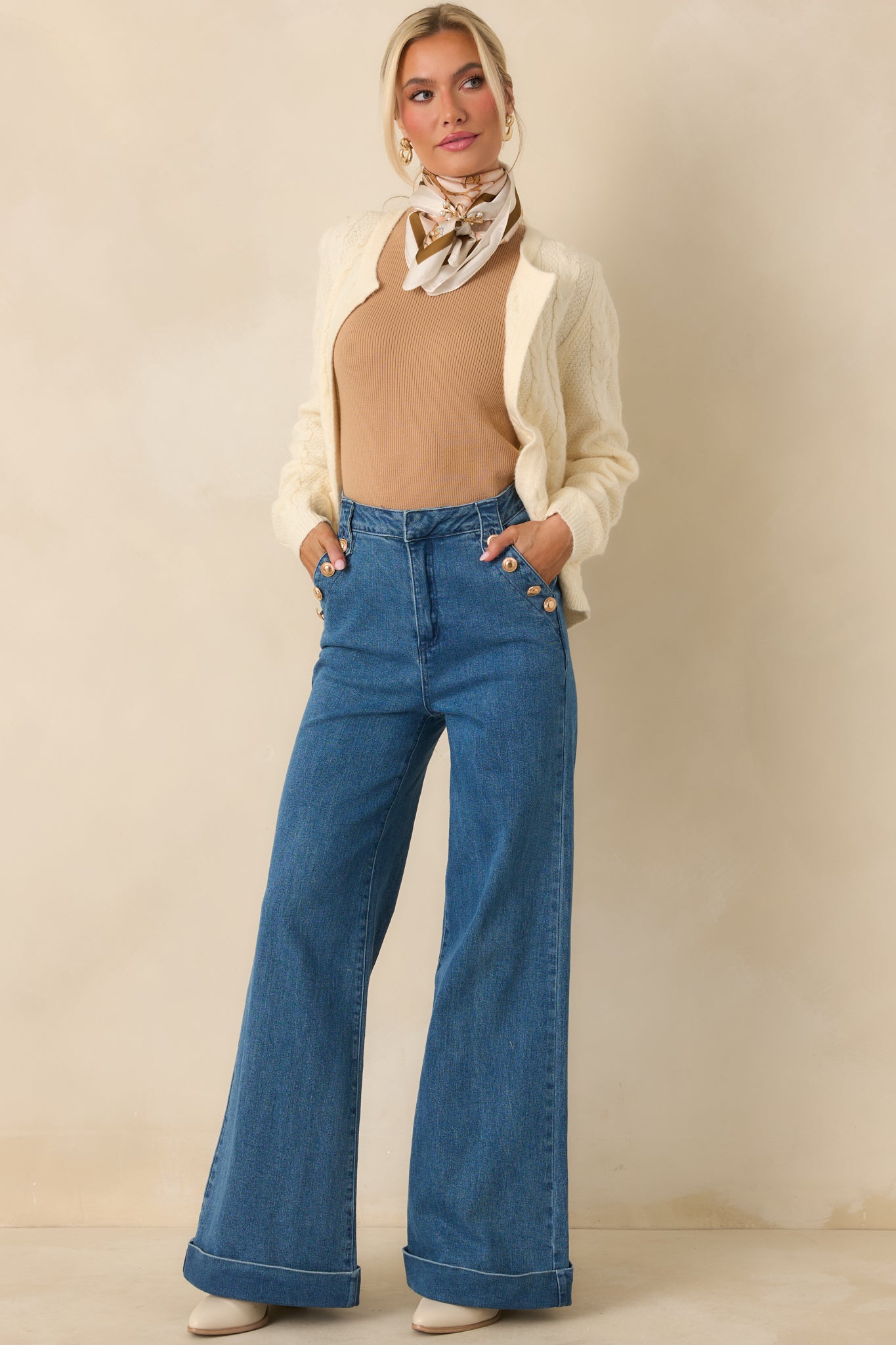 Ivory open-front cardigan with classic cable knit pattern, long sleeves, and relaxed fit with front patch pockets.