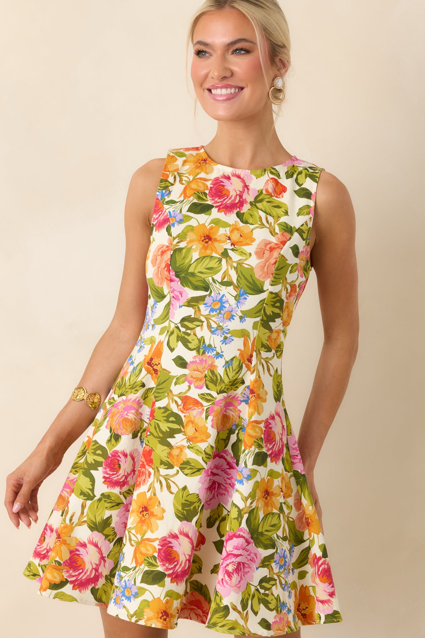 Ivory fabric with vibrant floral print and structured seam detailing along the fitted bodice.