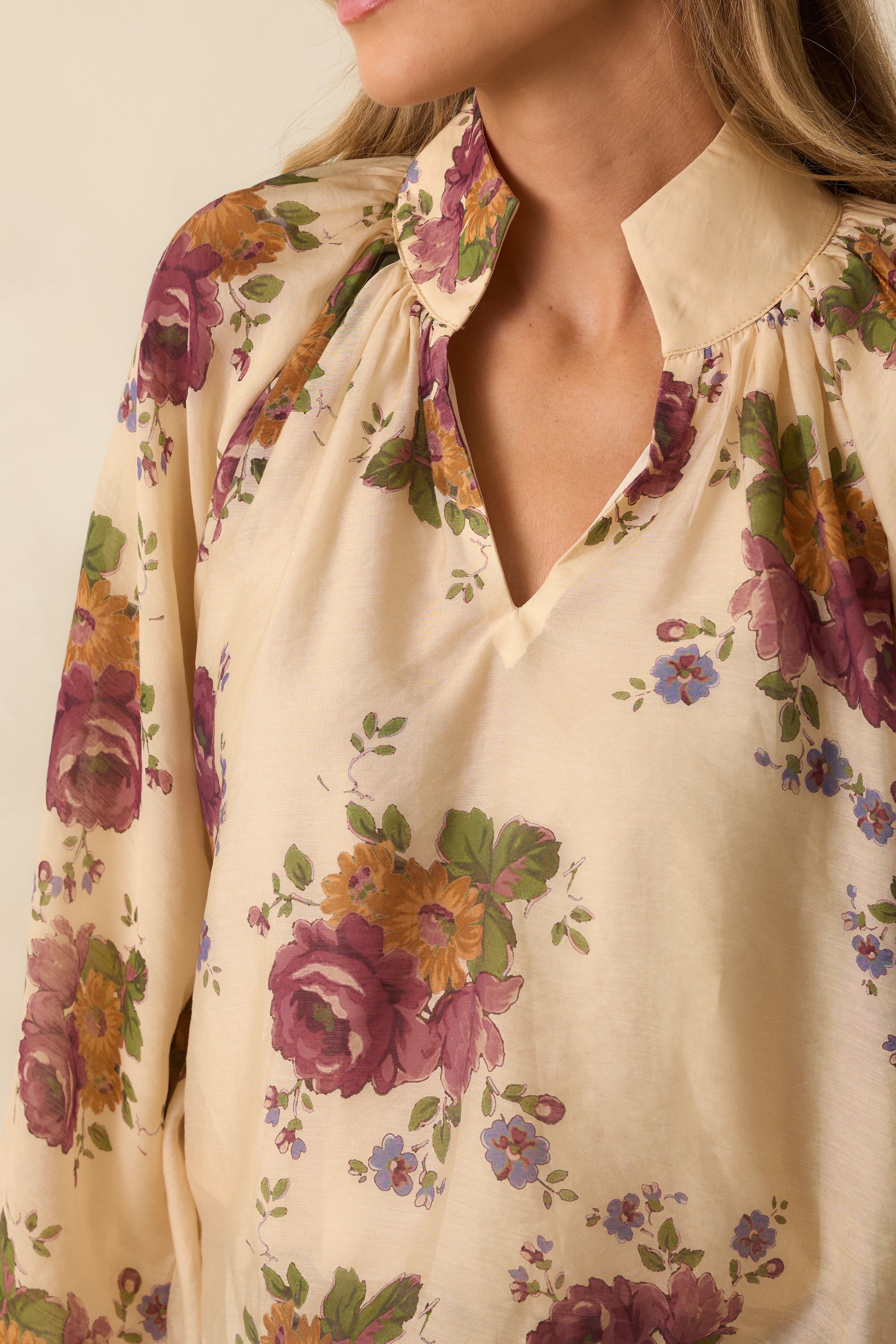 Close-up of the split neckline and gathered detailing with the ivory floral fabric.