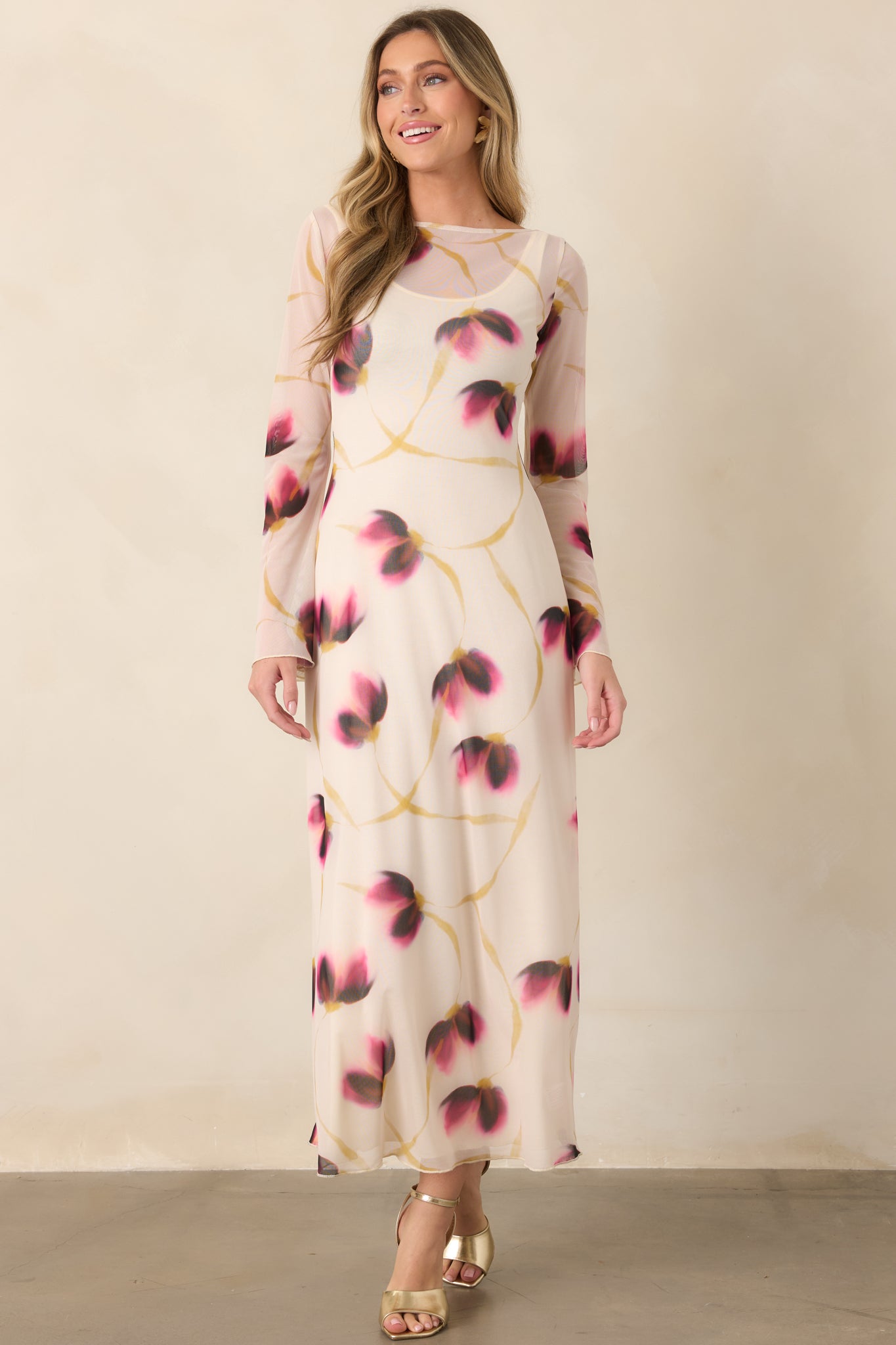 Long ivory floral dress with a close-fitting shape, wide neckline, long sleeves, and gently flared cuffs for a refined finish.