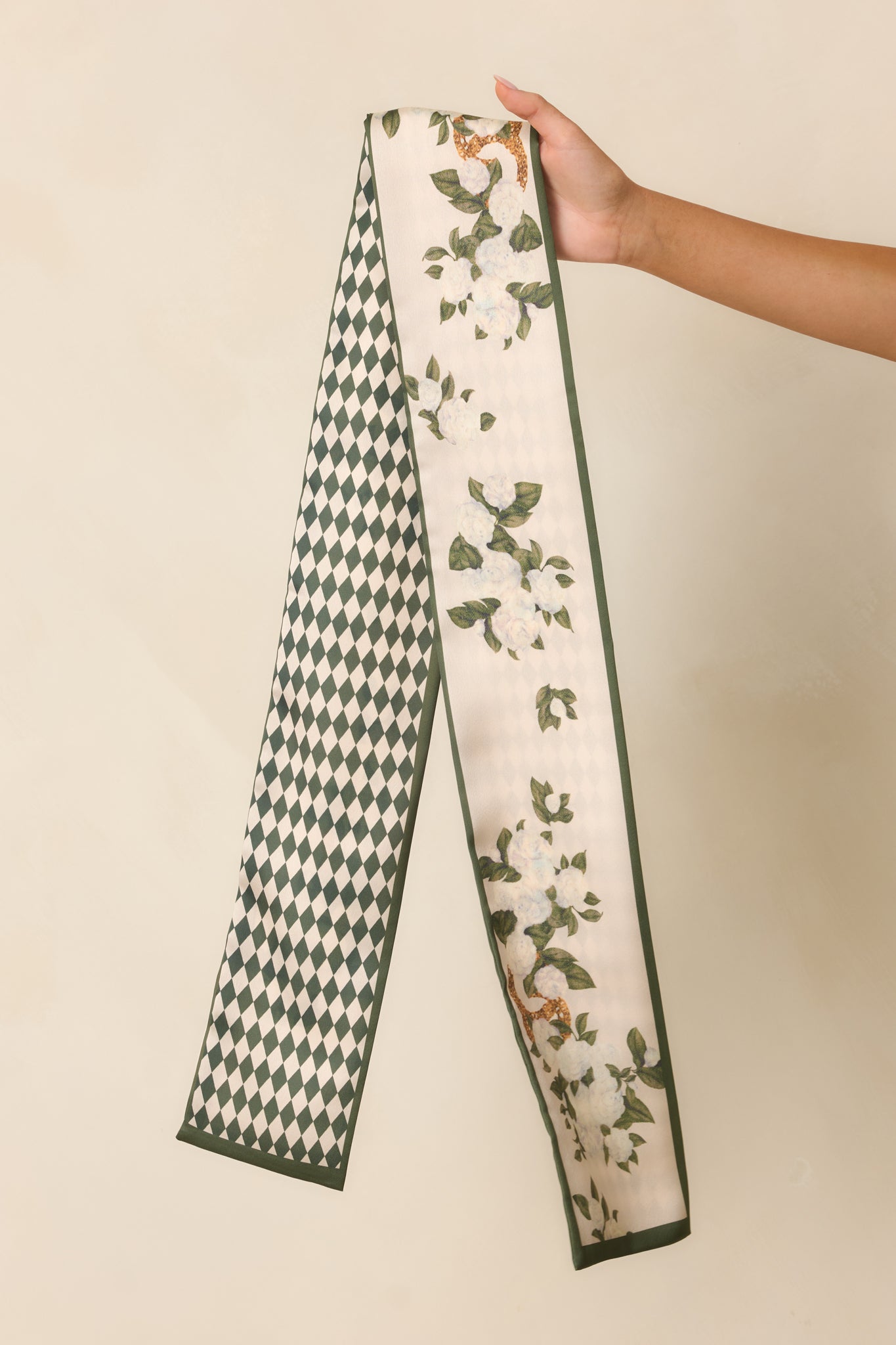 Detailed view of the ivory floral side featuring delicate blooms and subtle gold chain-inspired accents.