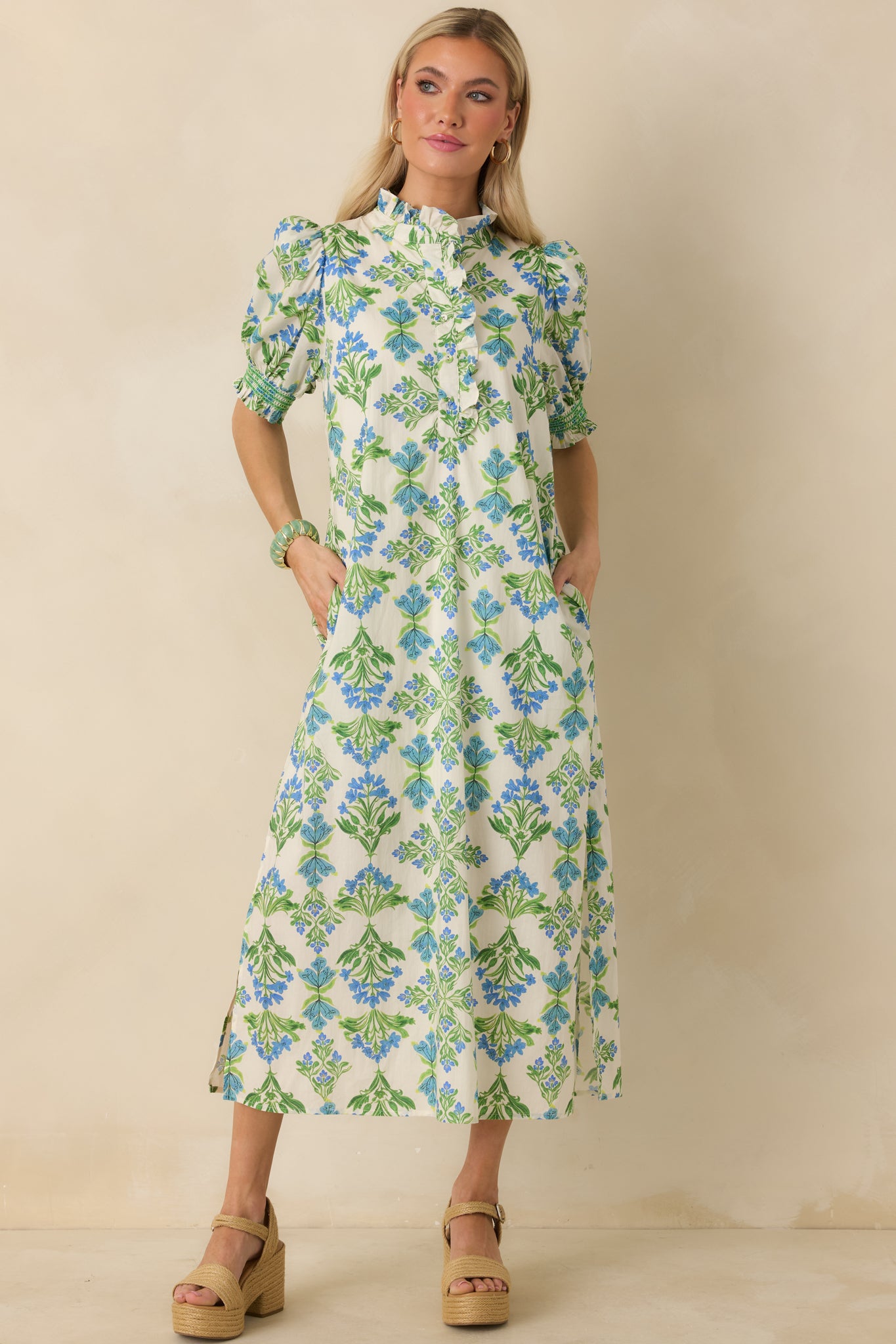Ivory floral maxi dress showcasing the soft ruffle neckline detail and airy puff sleeves for a breezy, casual feel.