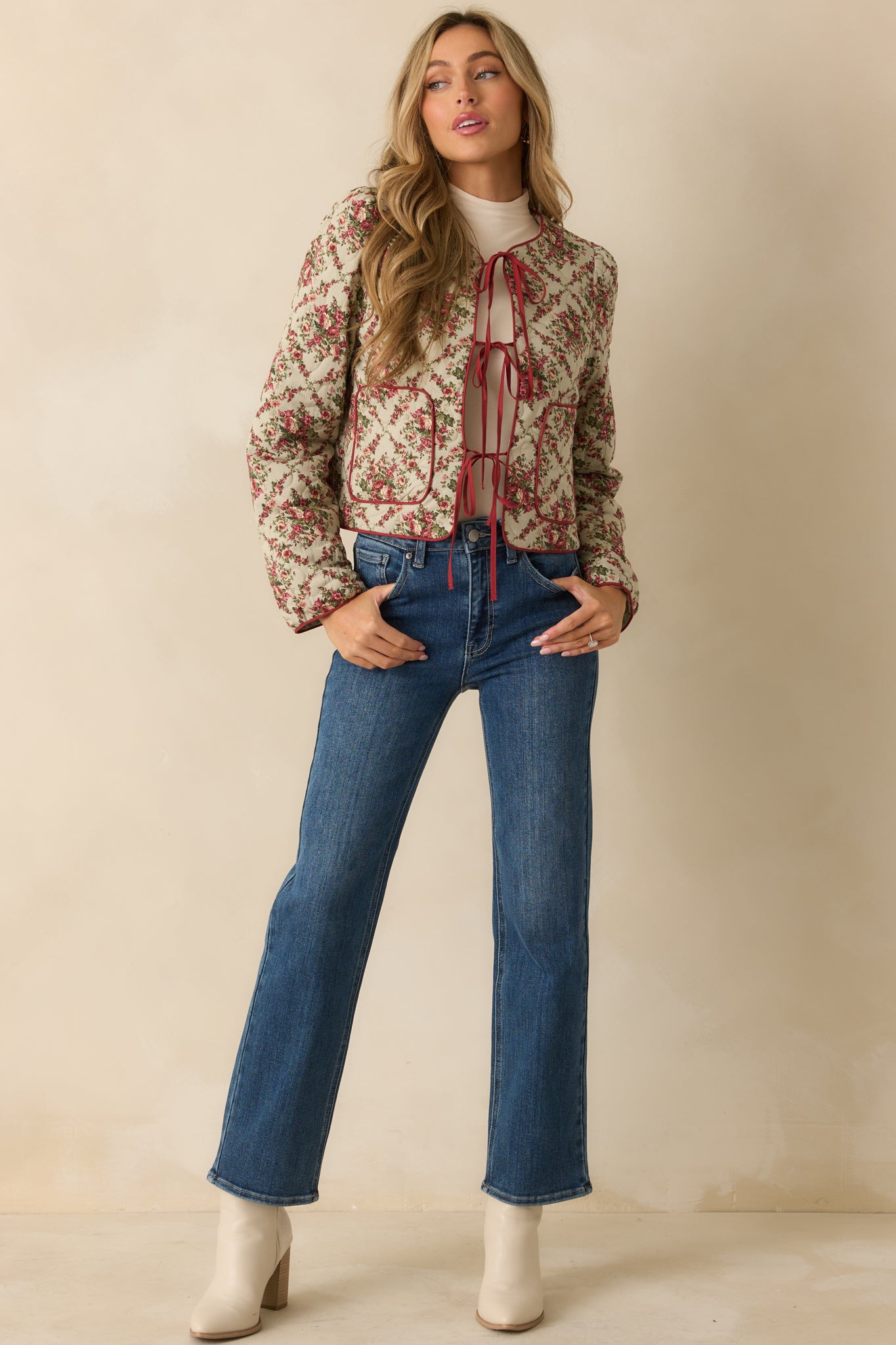 Front view of ivory floral quilted jacket featuring patch pockets and soft, lightly padded fabric.