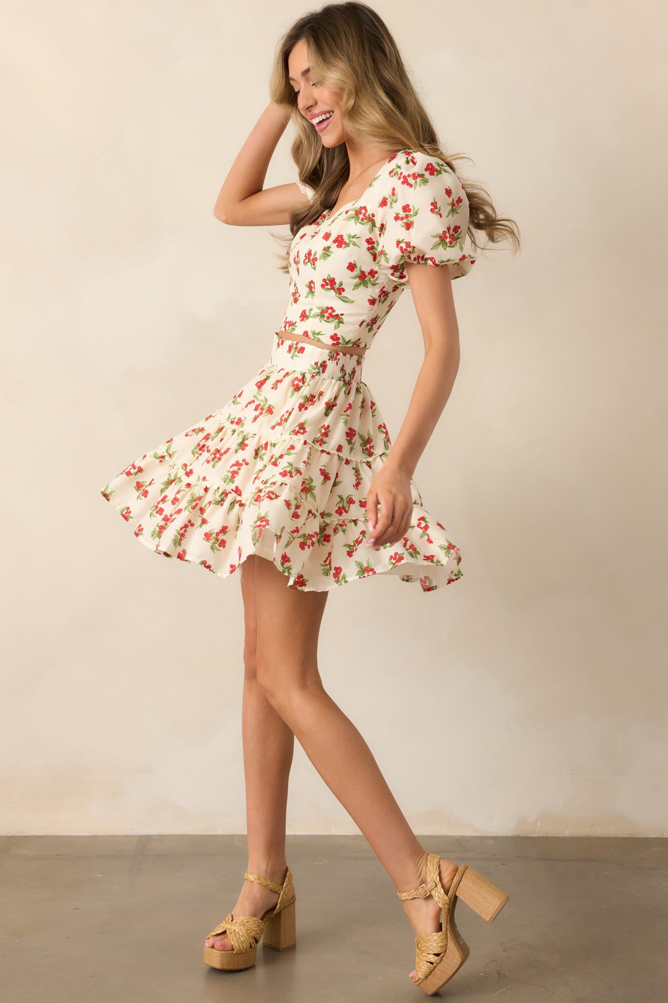 This ivory floral top showcases a cropped fit and smocked back for a flattering silhouette, paired with puff sleeves and a delicate lace neckline.