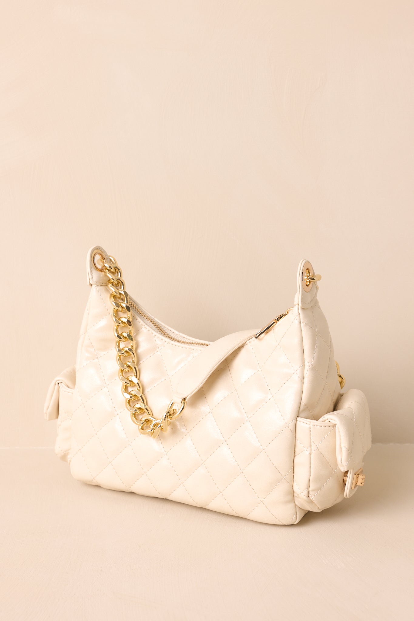 A back view of the handbag showing the quilted faux leather surface and clean structured silhouette.
