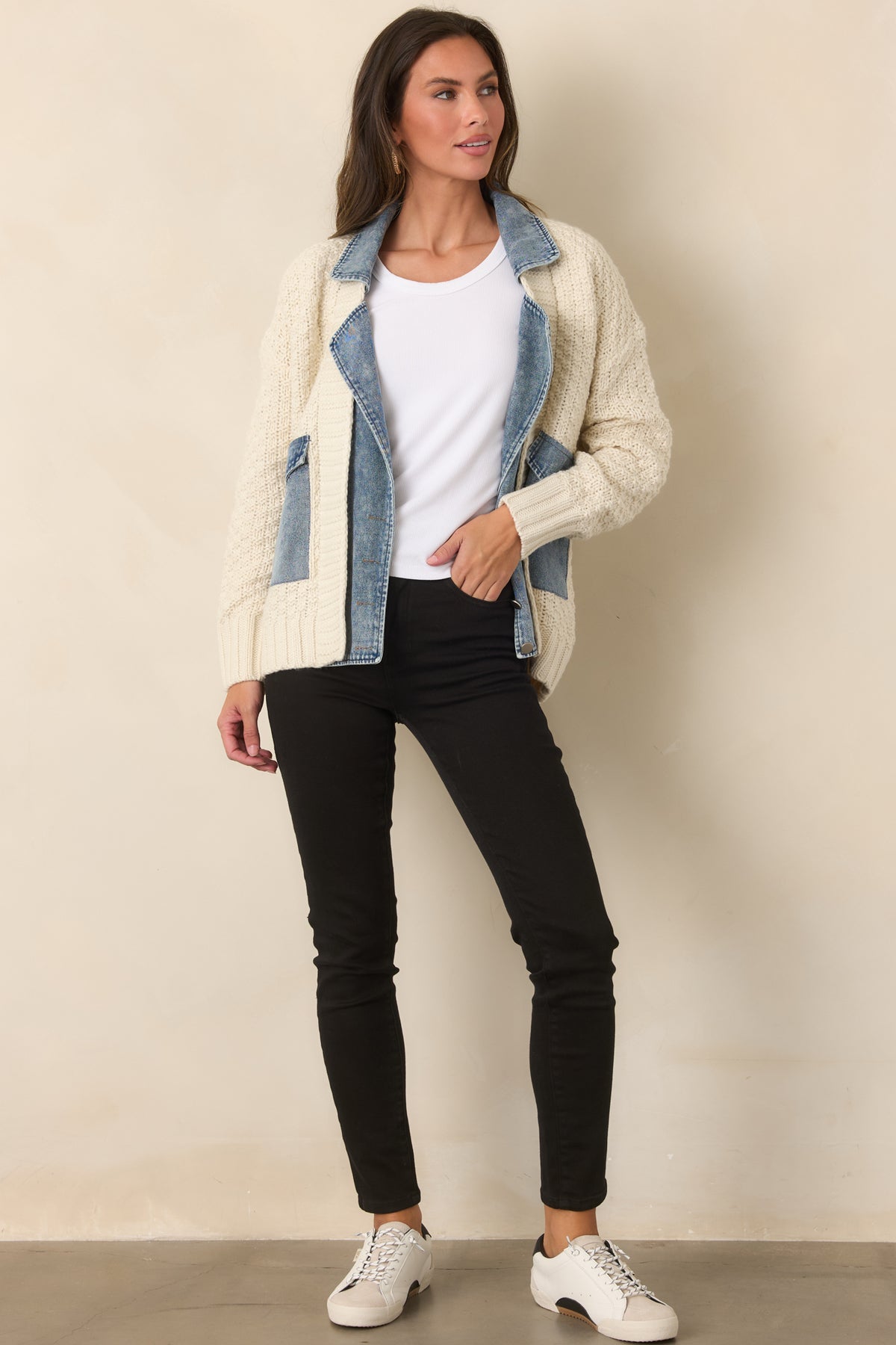 Mixed-media jacket combining a relaxed ivory knit body with contrasting denim details.