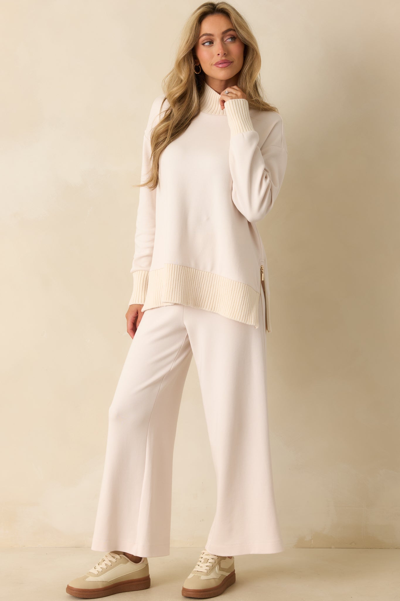 Front view of soft stretch knit pants featuring high-rise waist and flowing wide legs.