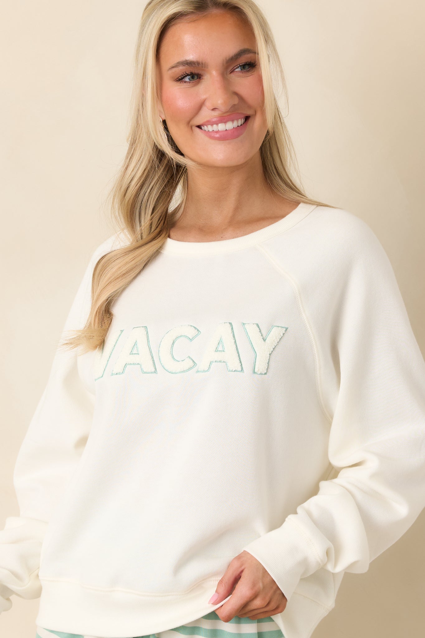 Ribbed cuff and hem detail shown on lightweight ivory knit with comfortable stretch.