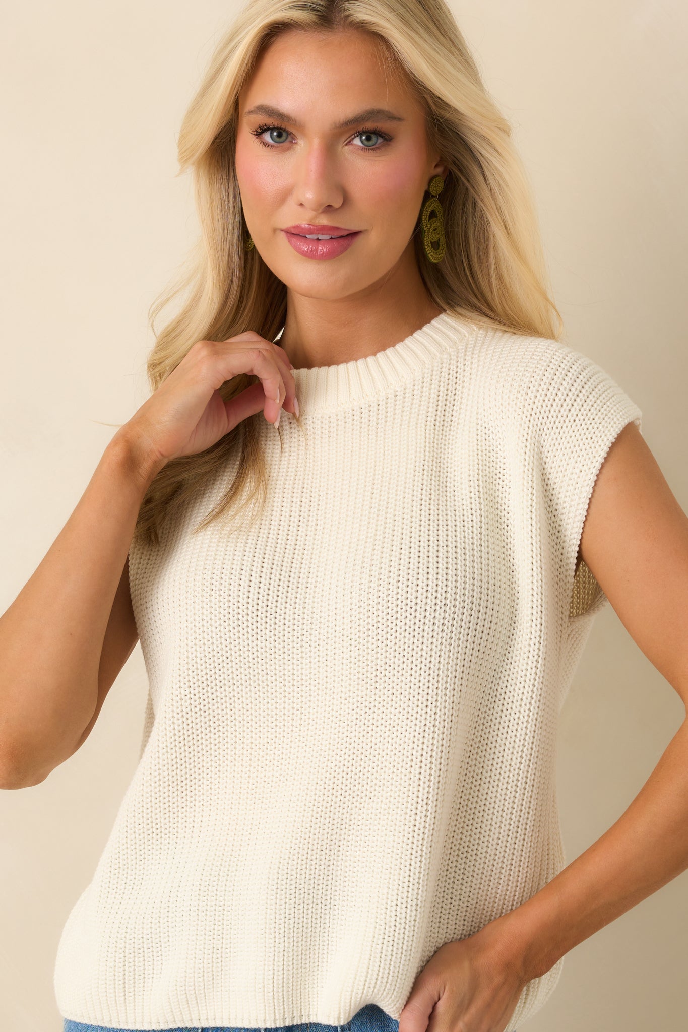 Relaxed fit and cap sleeve design visible on the ivory knit tank.