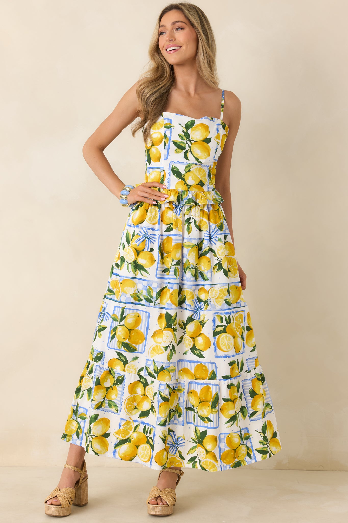 Ivory midi skirt with bright yellow lemons and green leaves, designed with hidden side pockets and a softly gathered elastic waistband.