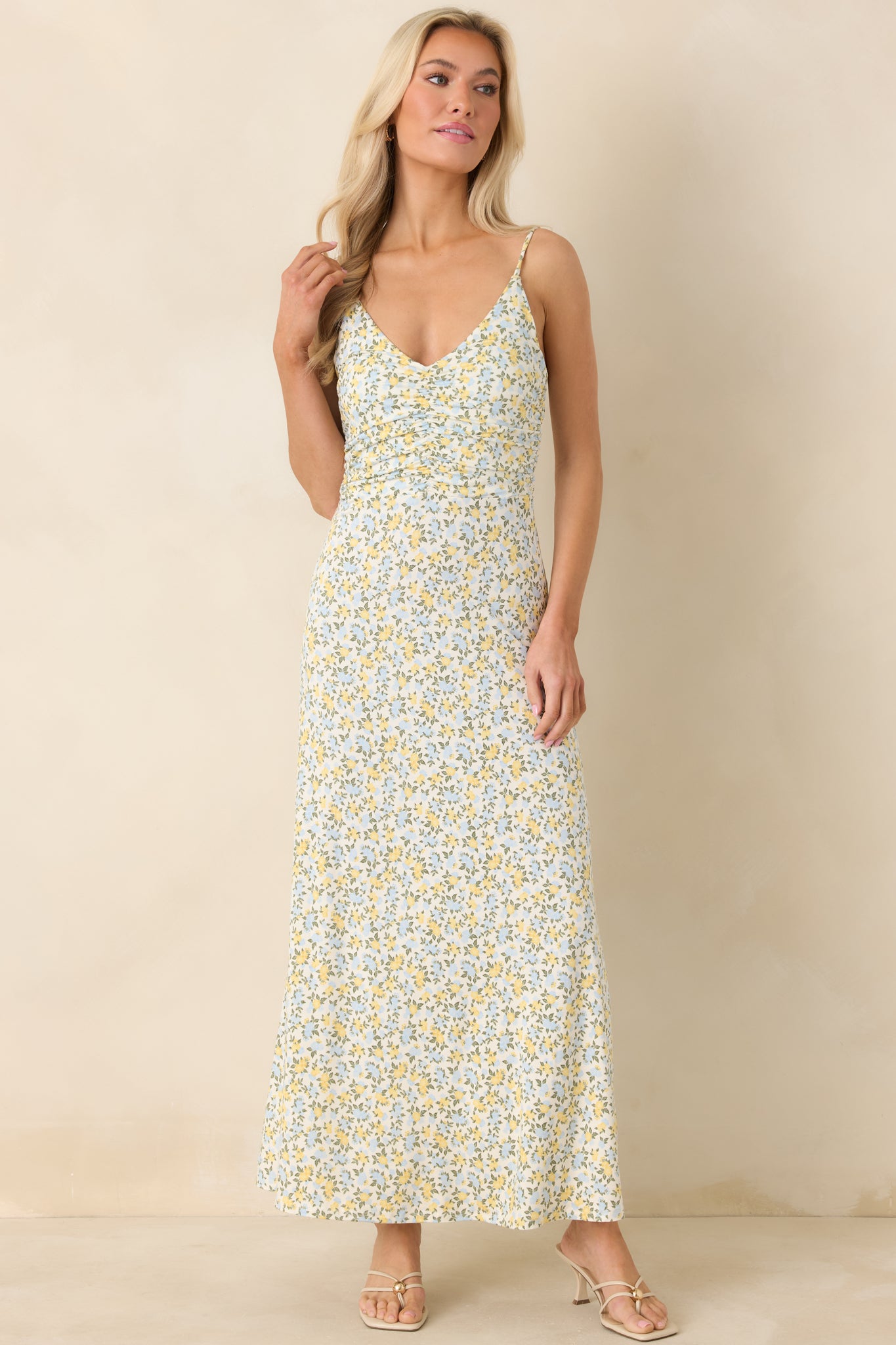 Maxi dress in ivory with ditsy floral print, featuring a comfortable ruched bodice and breezy ankle-length skirt.