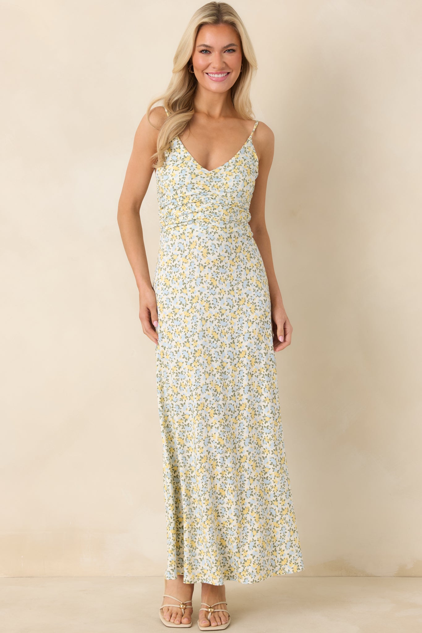 Ivory maxi dress with adjustable straps, ruched top for shape, and gentle A-line silhouette that skims into a flowy skirt.