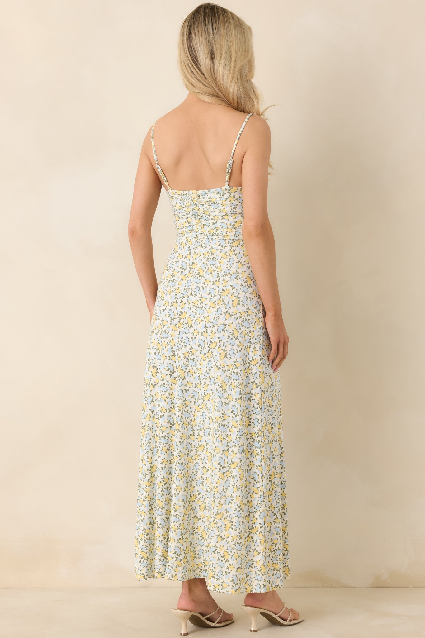 Ivory maxi dress displaying adjustable spaghetti straps and a smooth rear silhouette with flowy ankle-length skirt.