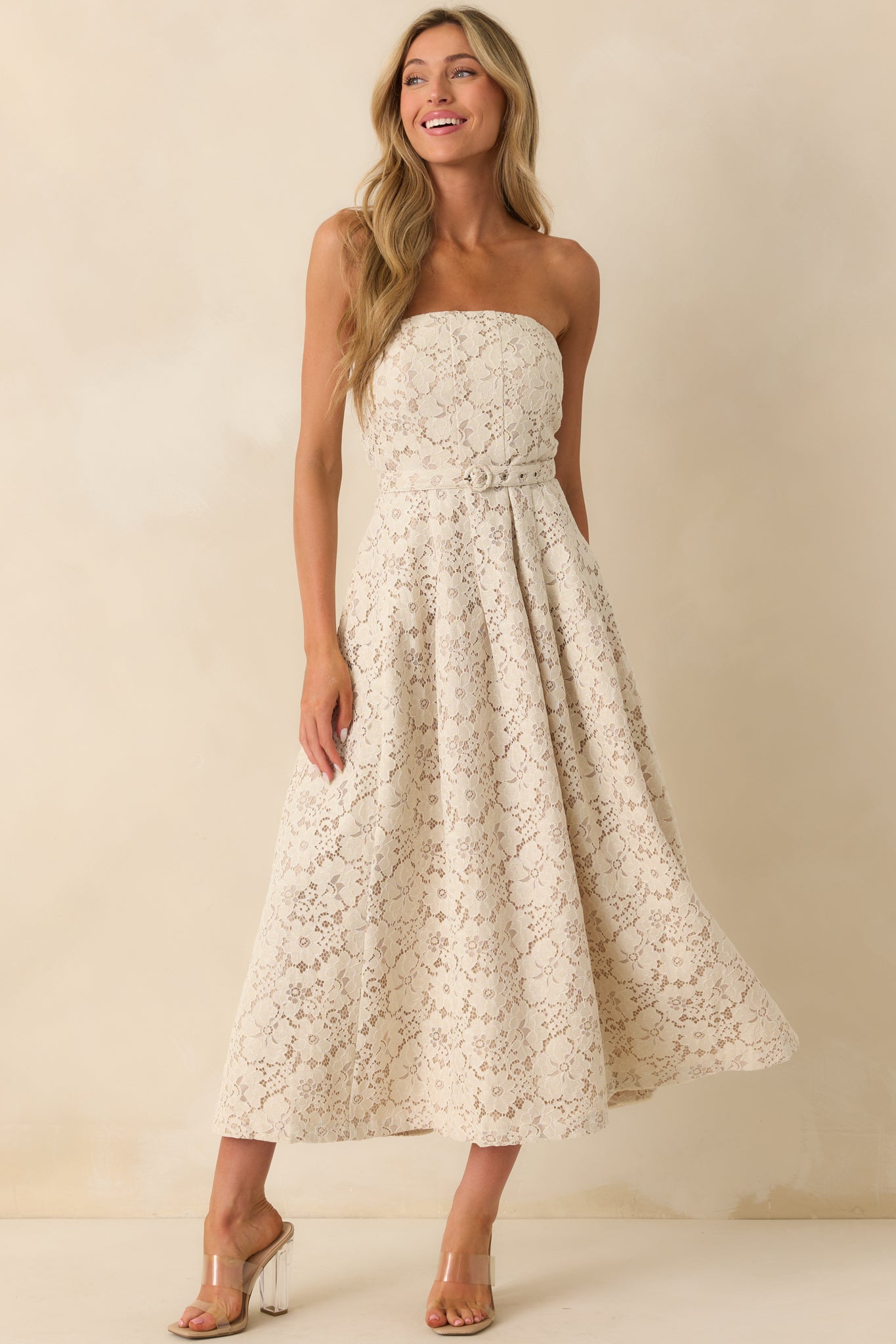 Front view of the ivory midi dress featuring a lace embroidered overlay and strapless neckline.