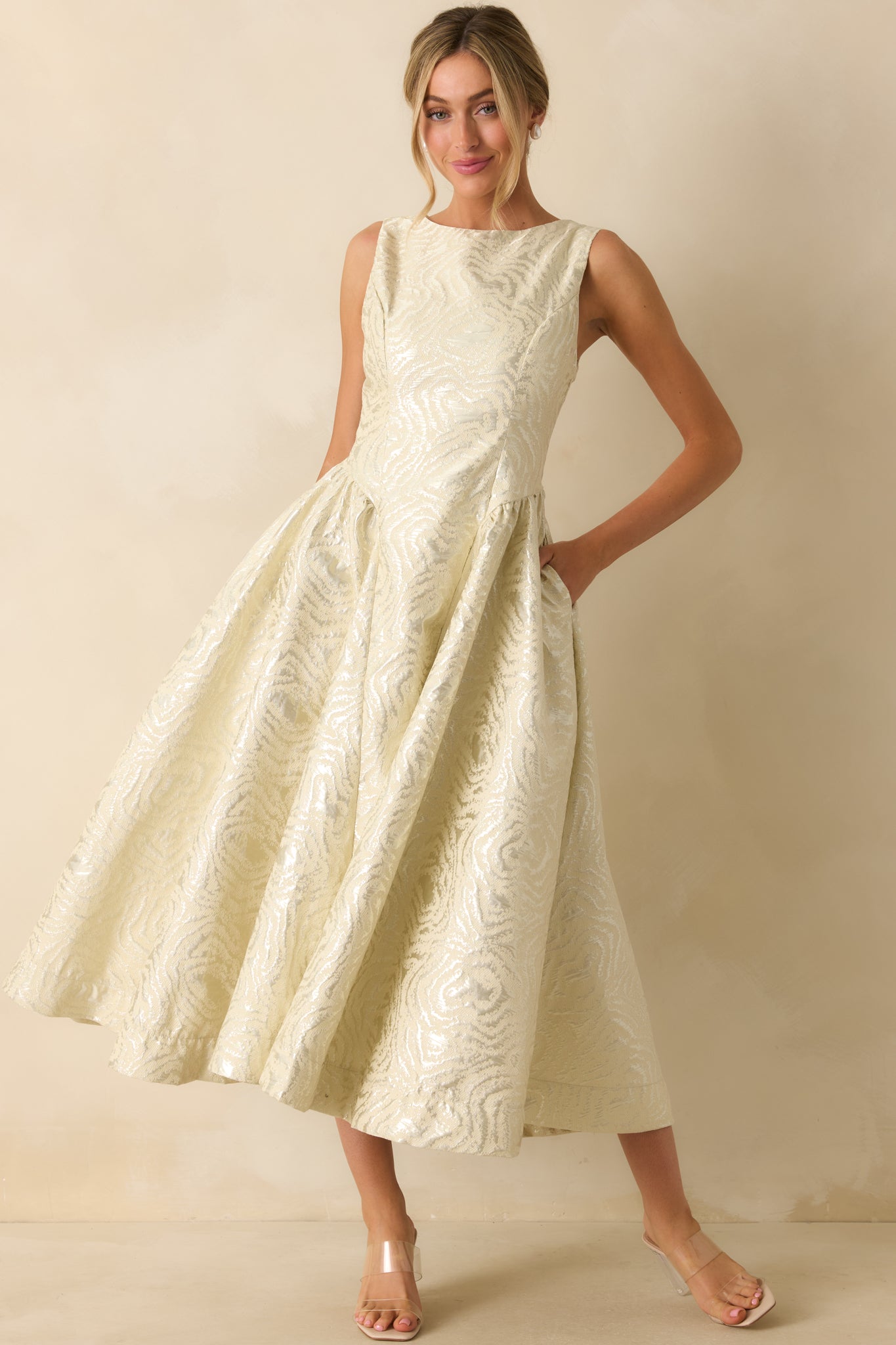 Ivory midi dress with a sleek scoop neckline and softly flared skirt for a refined finish.